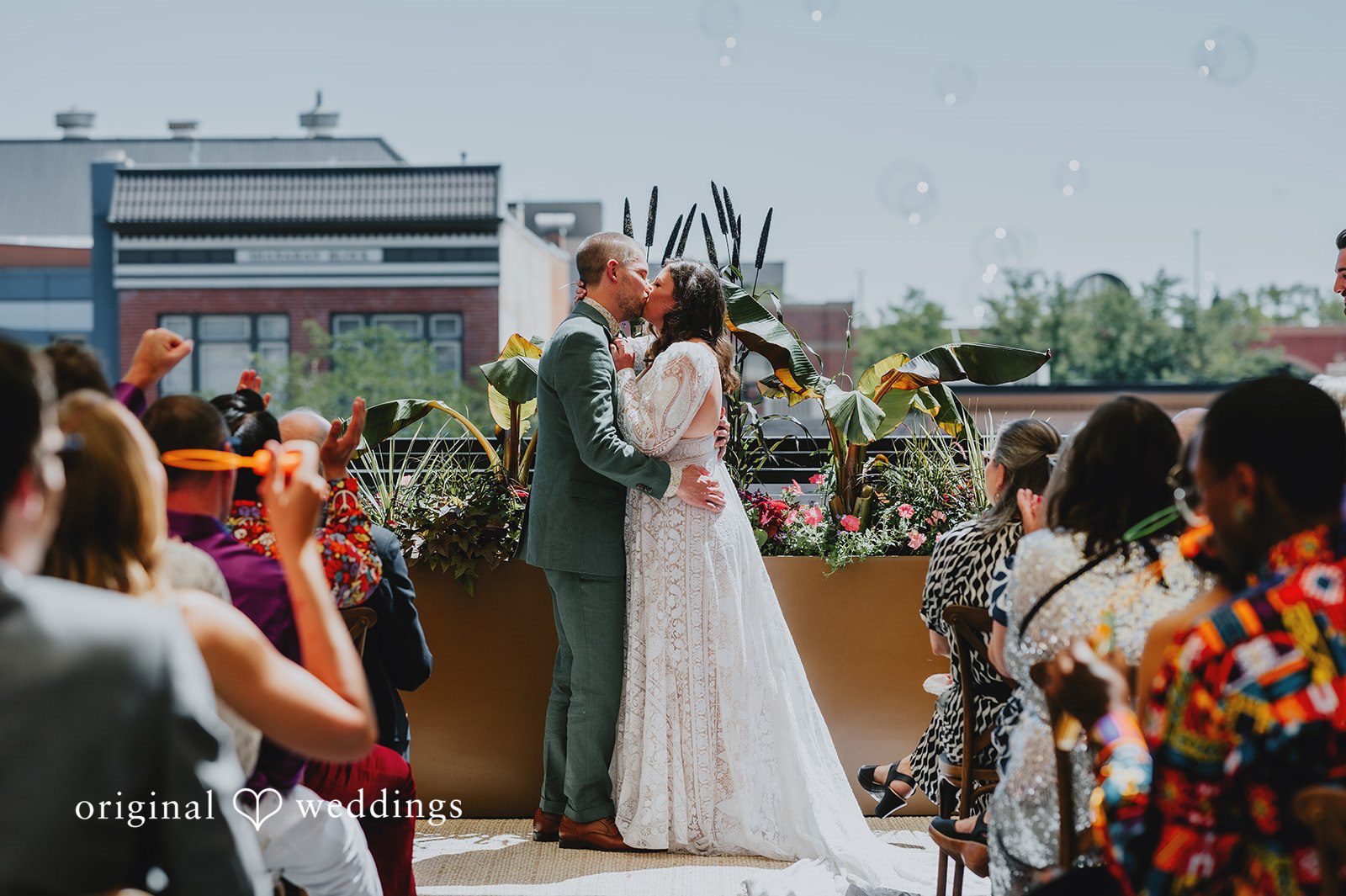 Elizabeth + Willis Bride and groom kissing at the altar surrounded by their wedding party.