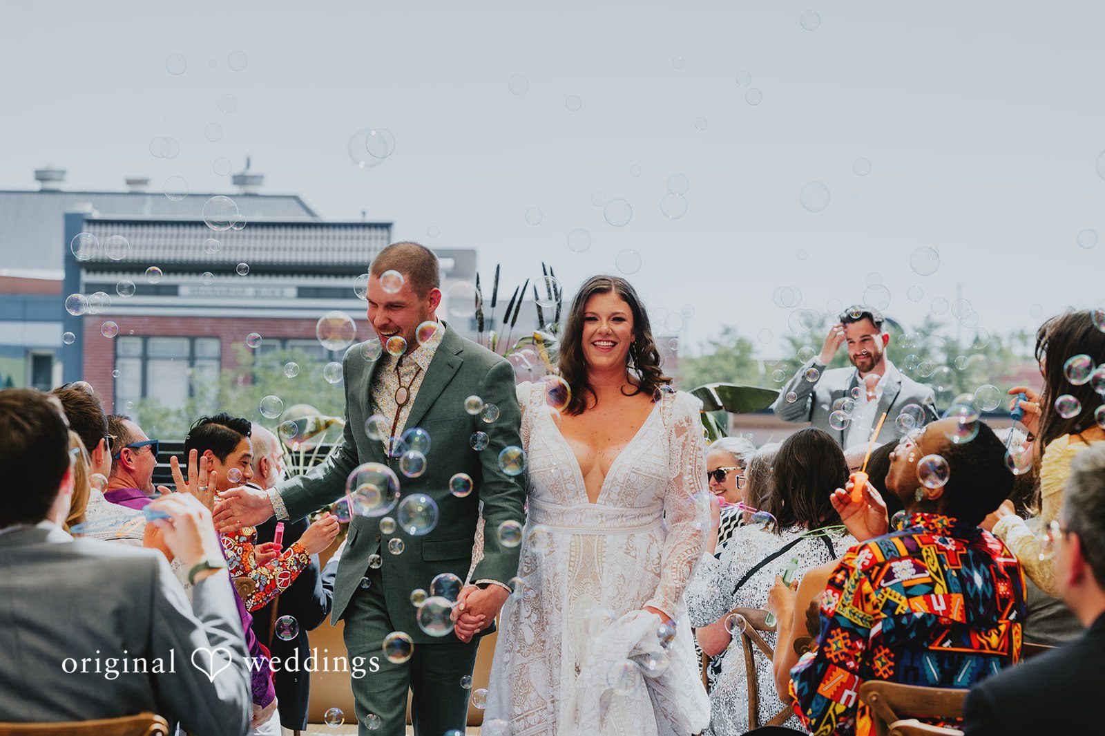 Elizabeth + Willis Newlyweds walking down the aisle together as guests look on.