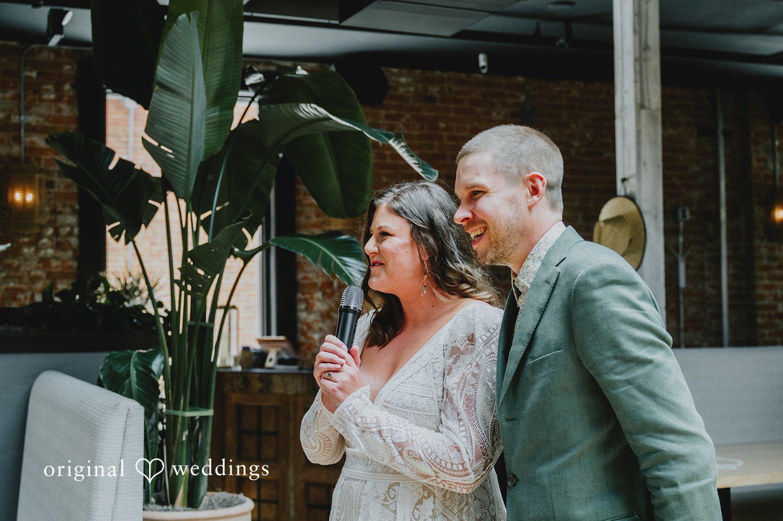 Elizabeth + Willis Bride speaking into a microphone while standing beside the groom.