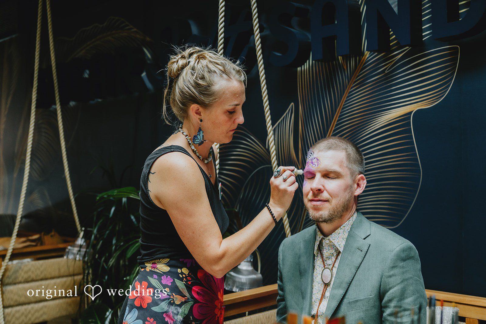 Elizabeth + Willis Woman adjusting a man's hair while he sits in a chair.