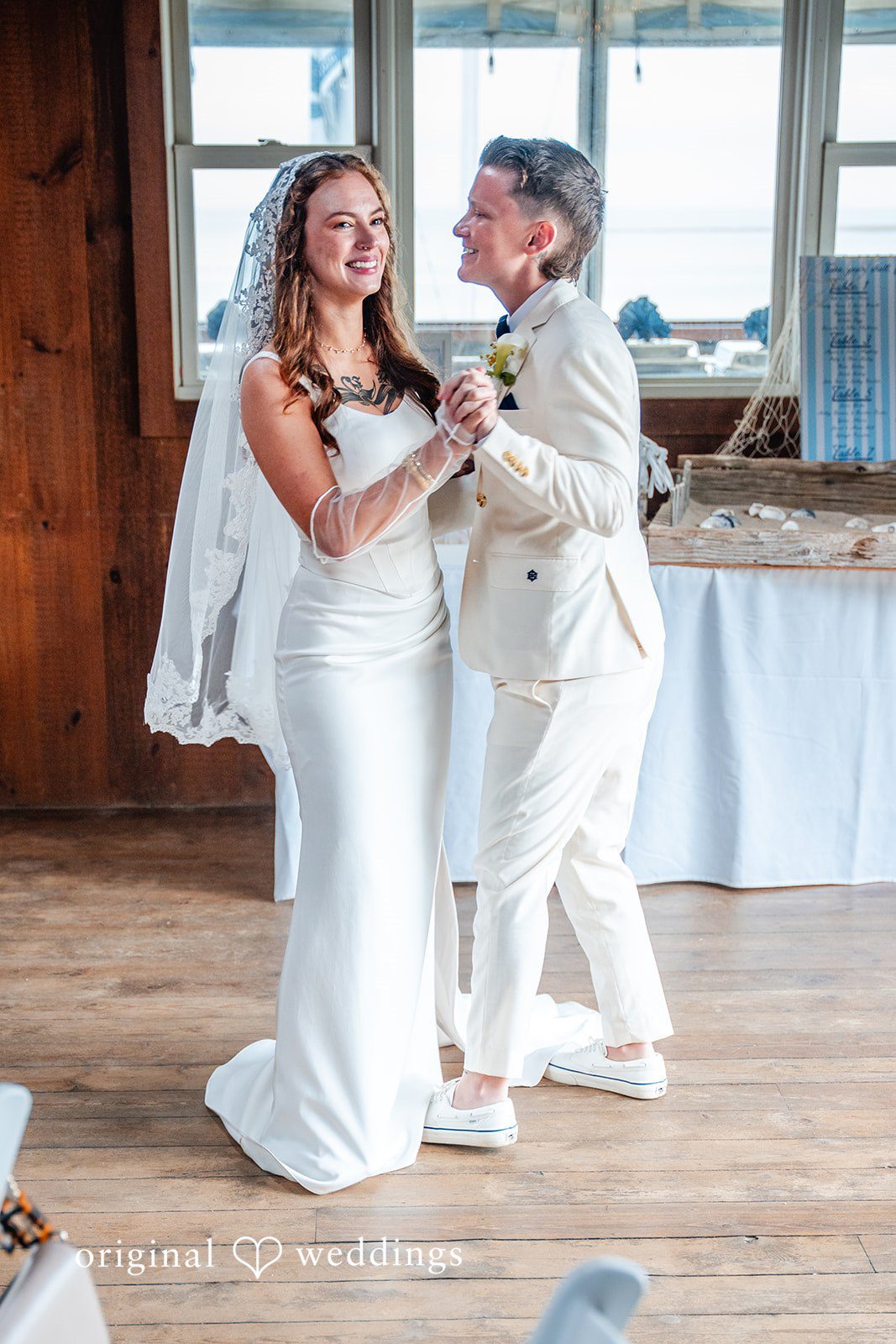 Jacqueline + Sarah A newlywed couple smiling and enjoying their first dance together.