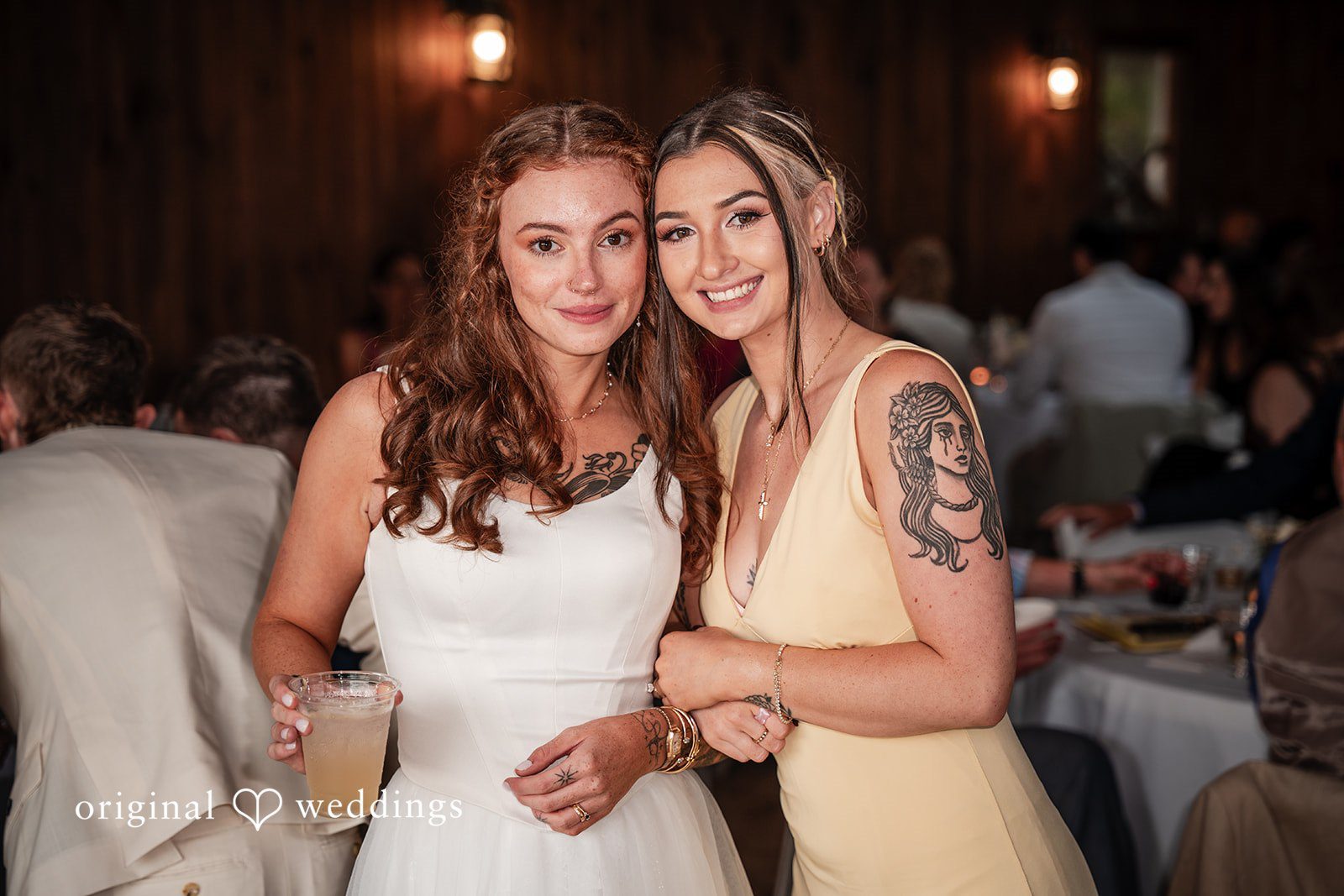Jacqueline + Sarah Bride and women smiling together for a portrait during the reception.