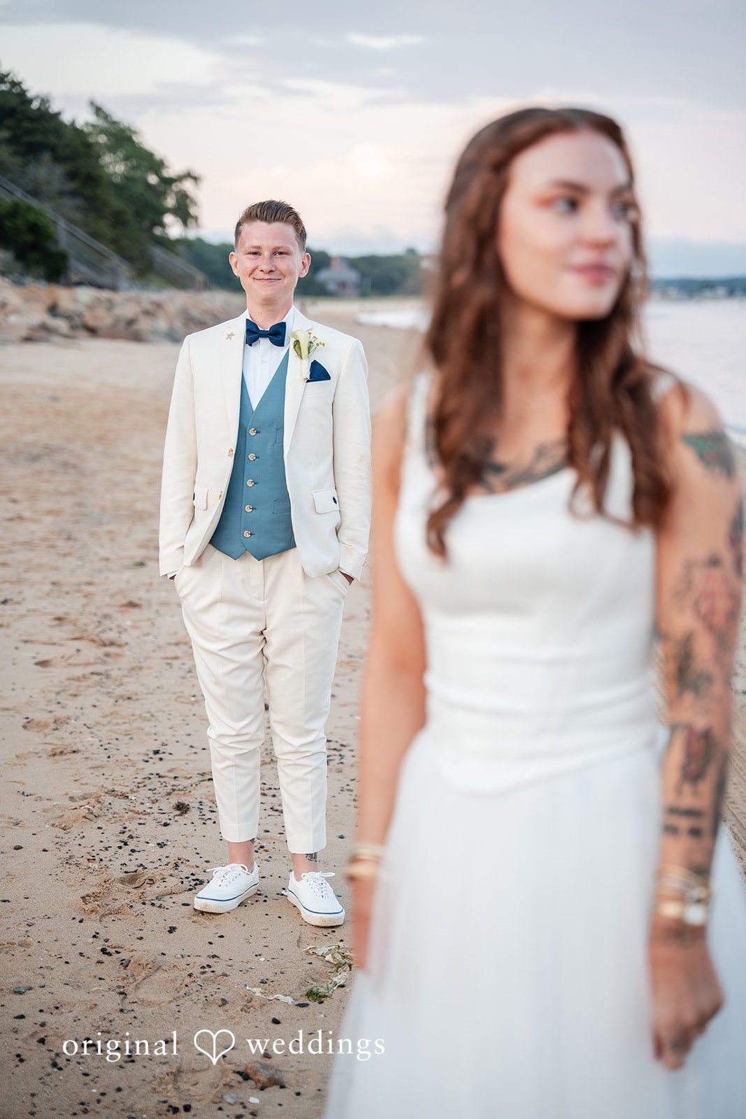 Jacqueline + Sarah A bride and groom standing side-by-side smiling together.