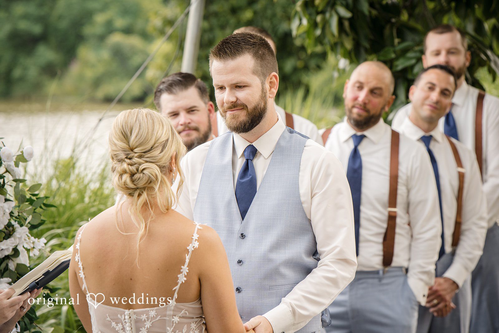 Morgan + Colin A groom standing with his groomsmen while watching his bride approach.