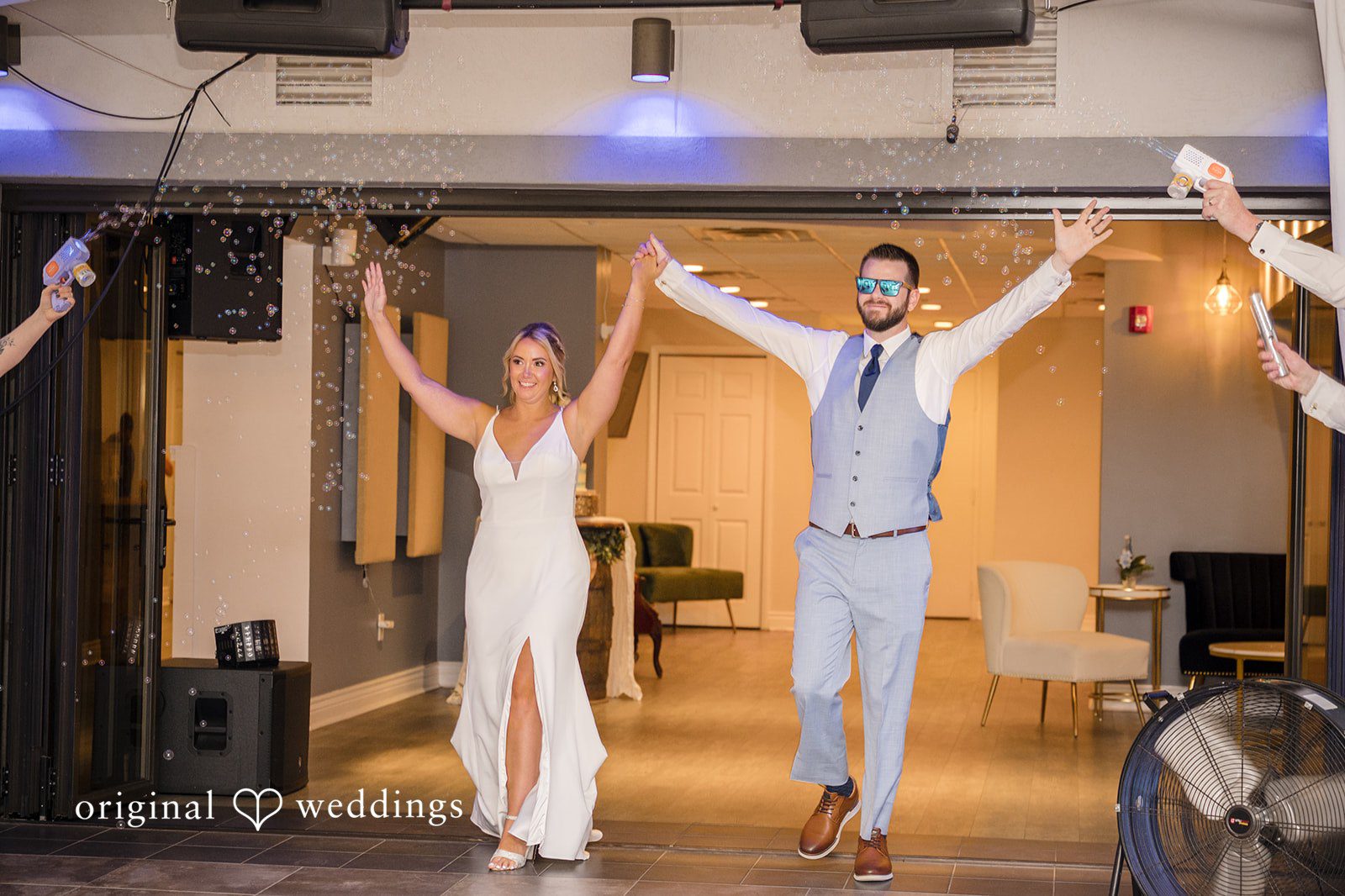Morgan + Colin A newly married bride and groom making a grand, high-energy entrance into their reception.