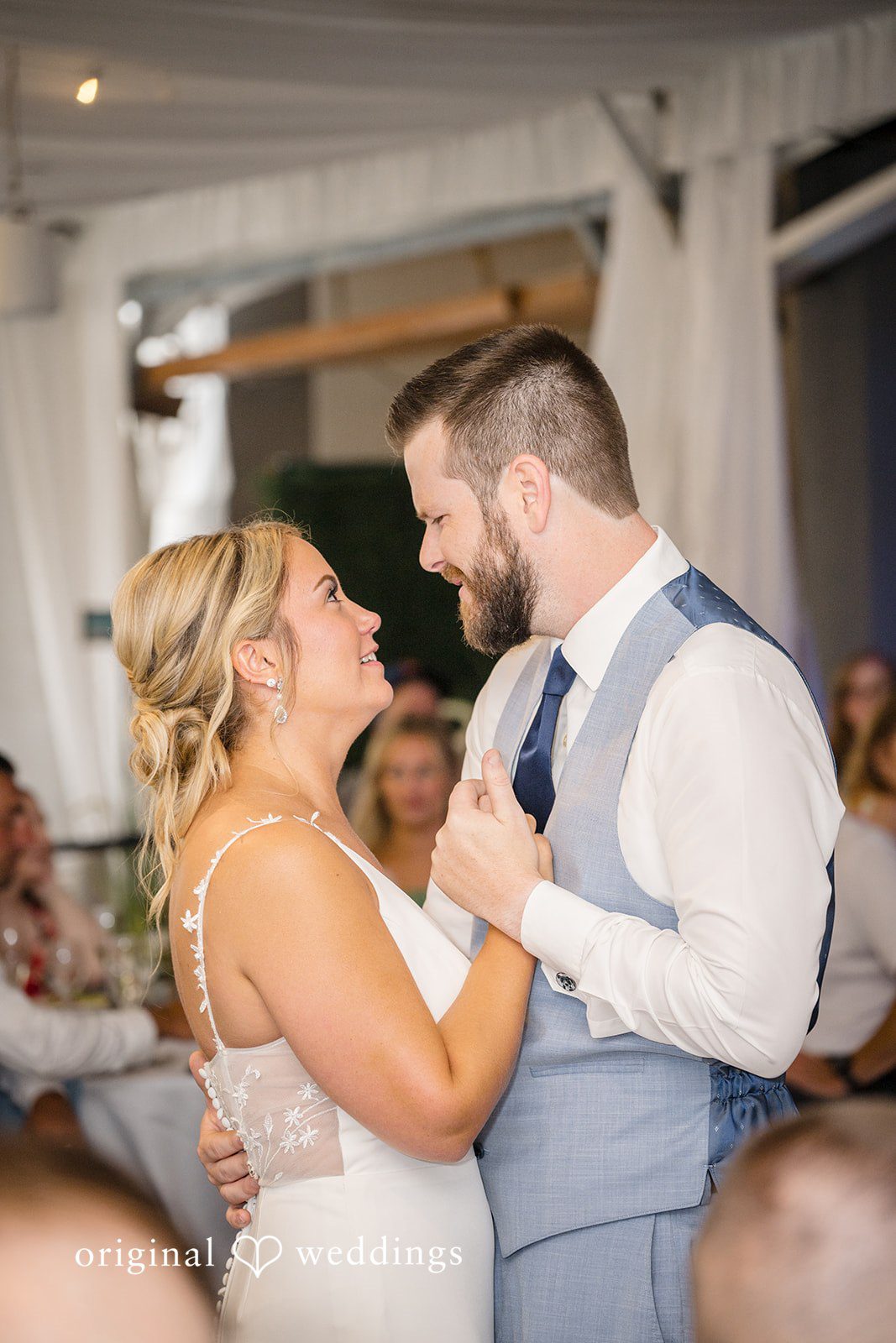 Morgan + Colin A close-up of a smiling bride and groom dancing together during their wedding reception.