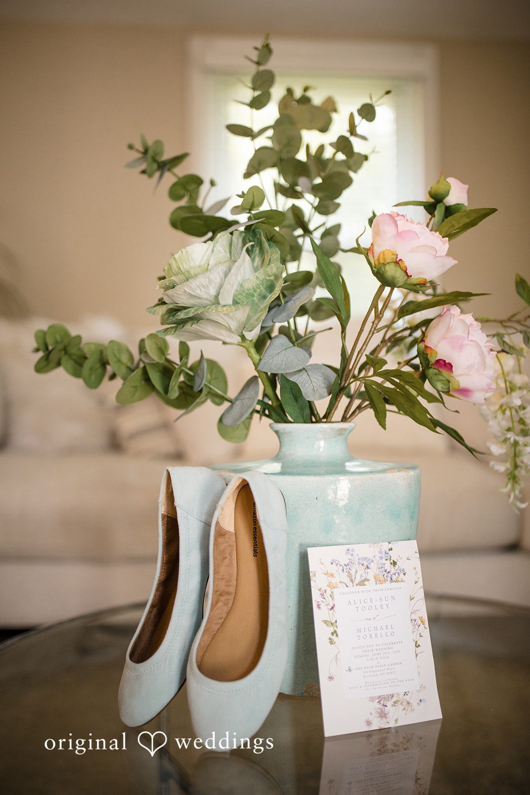 Alice-sun + Michael Close up of bridal shoes placed beautifully along a vase