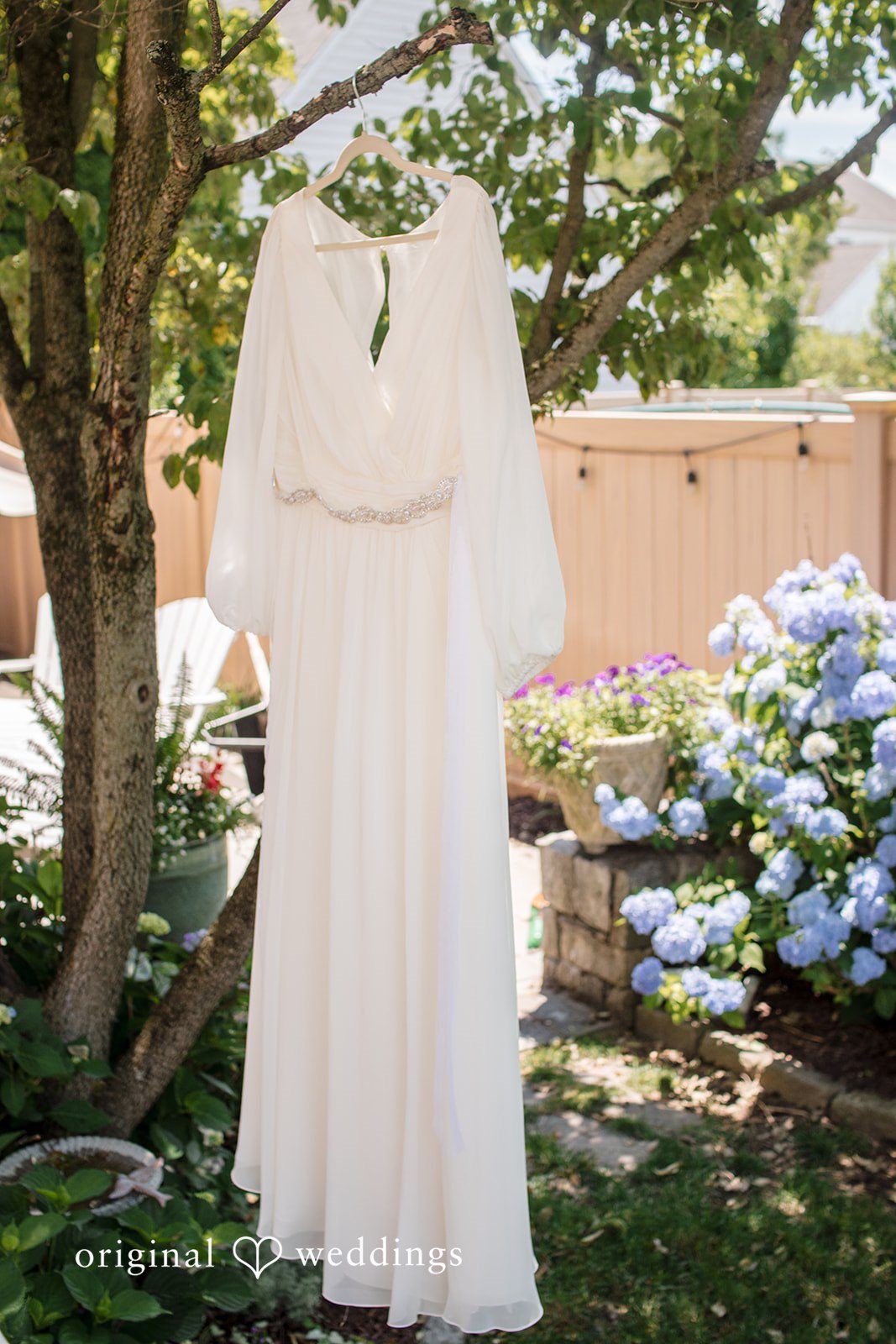 Alice-sun + Michael Beautiful picture of wedding gown hanged on a tree in a backyard