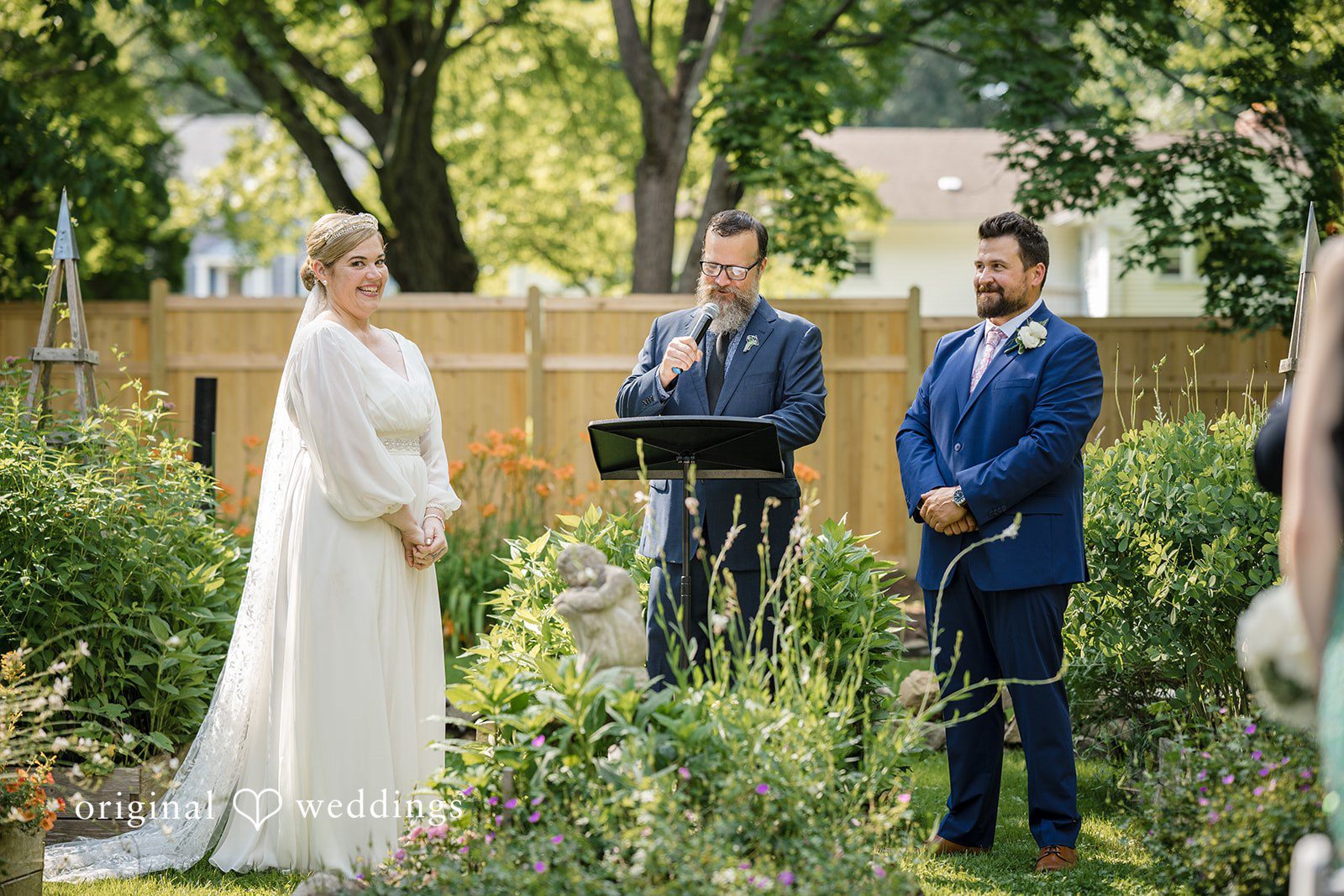 Alice-sun + Michael New York wedding photography by Original Weddings capturing the bride and groom listening to the priest and looking towards the guests