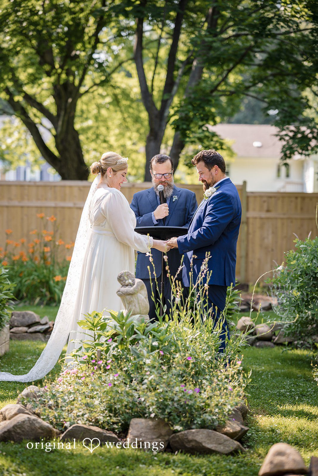 Alice-sun + Michael Bride and groom exchanging vows during wedding ceremony in a backyard