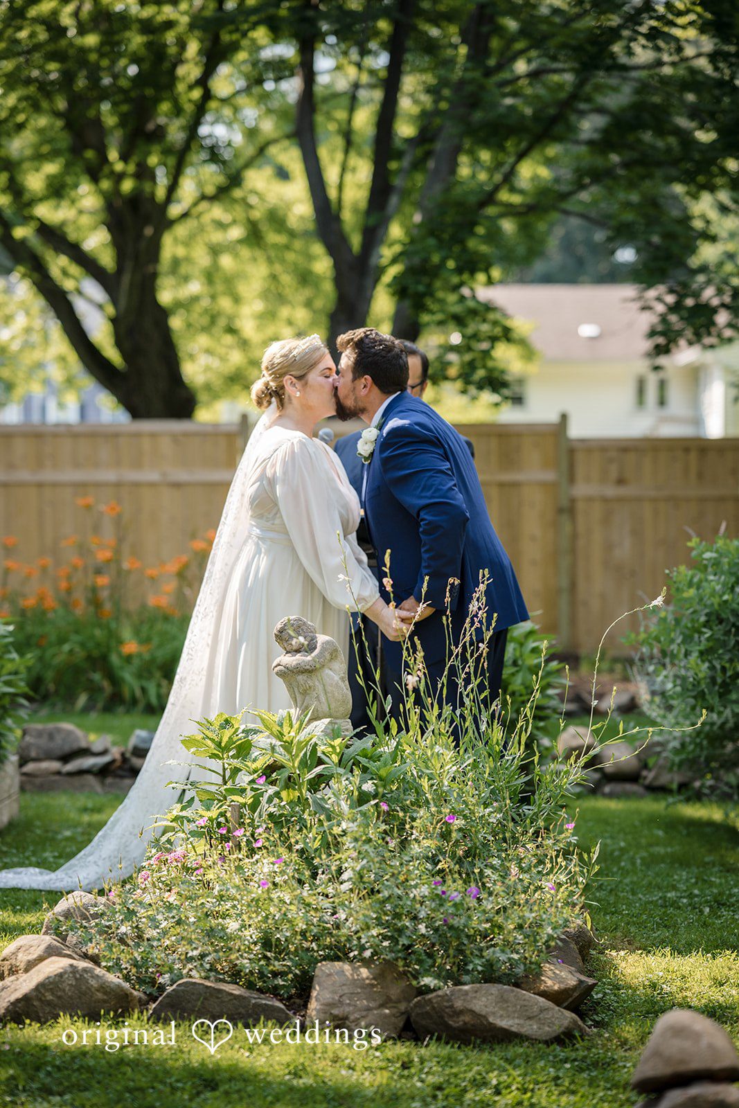 Alice-sun + Michael Bride and groom sharing their first kiss after wedding ceremony