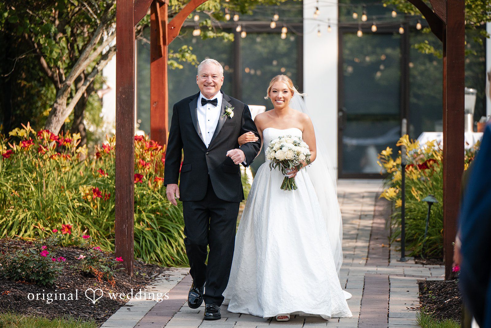 Nikki + Charlie The bride's father escorts the bride down the aisle