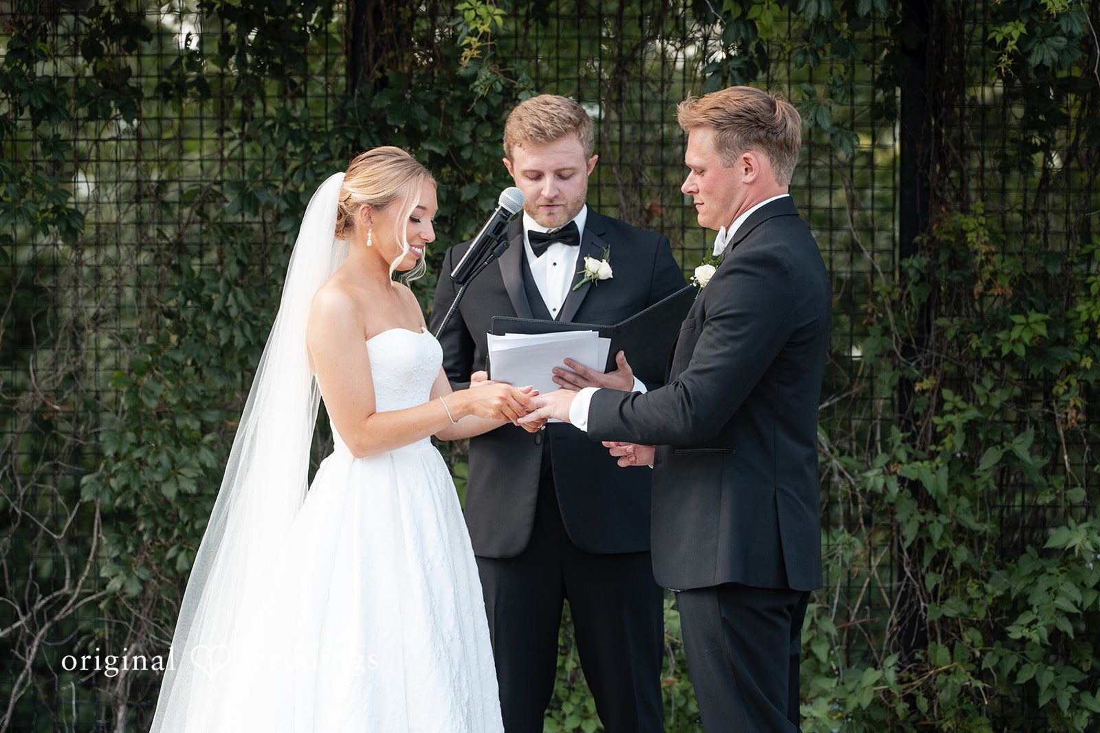 Nikki + Charlie Bride puts a ring on the groom's finger