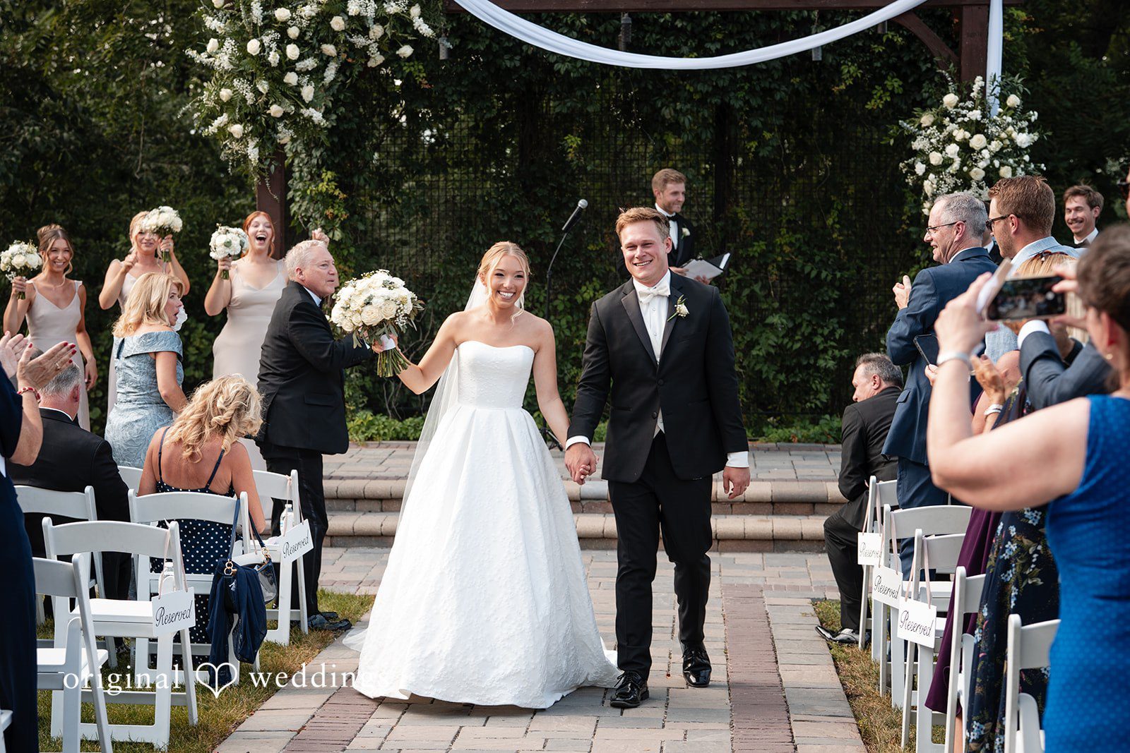 Nikki + Charlie The couple joyfully leaves the aisle
