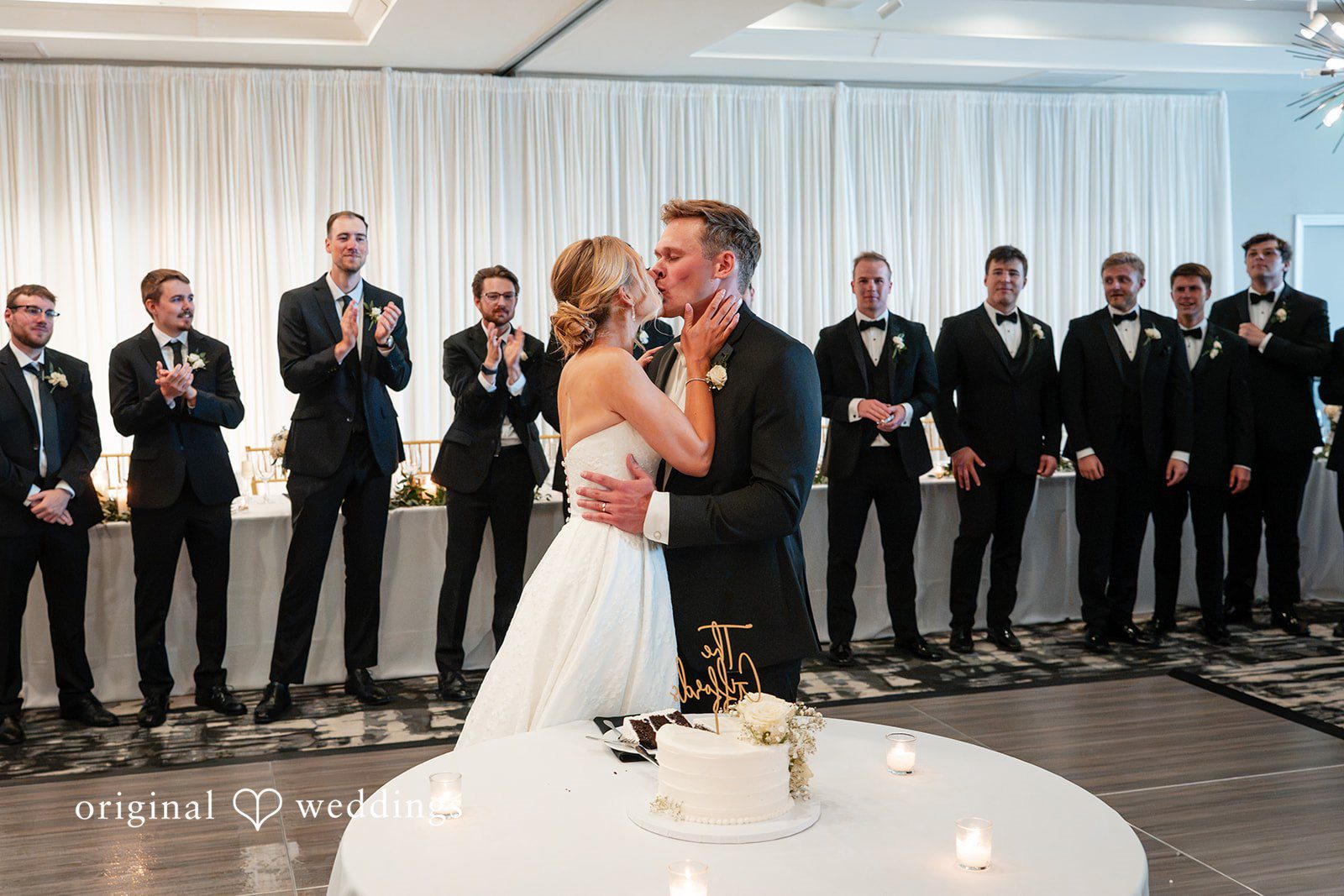 Nikki + Charlie The couple shares a kiss at the reception hall
