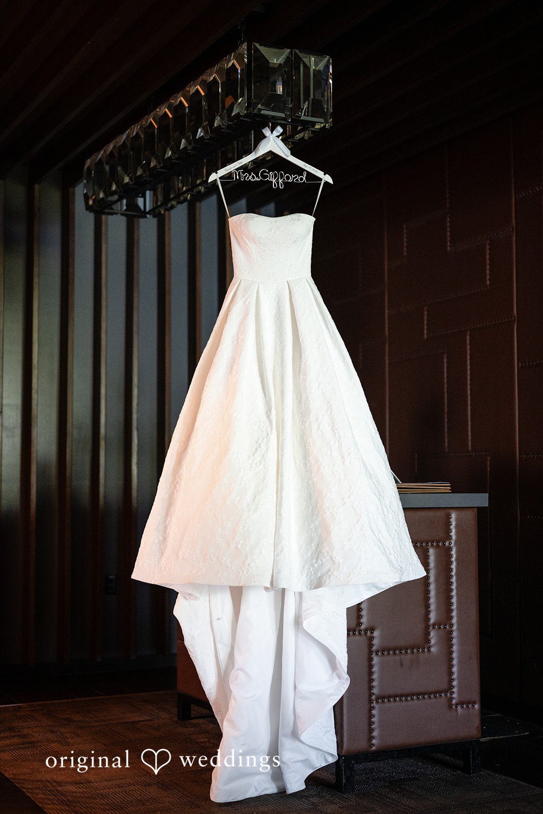 Nikki + Charlie The bride's wedding gown gracefully hanging in the suite
