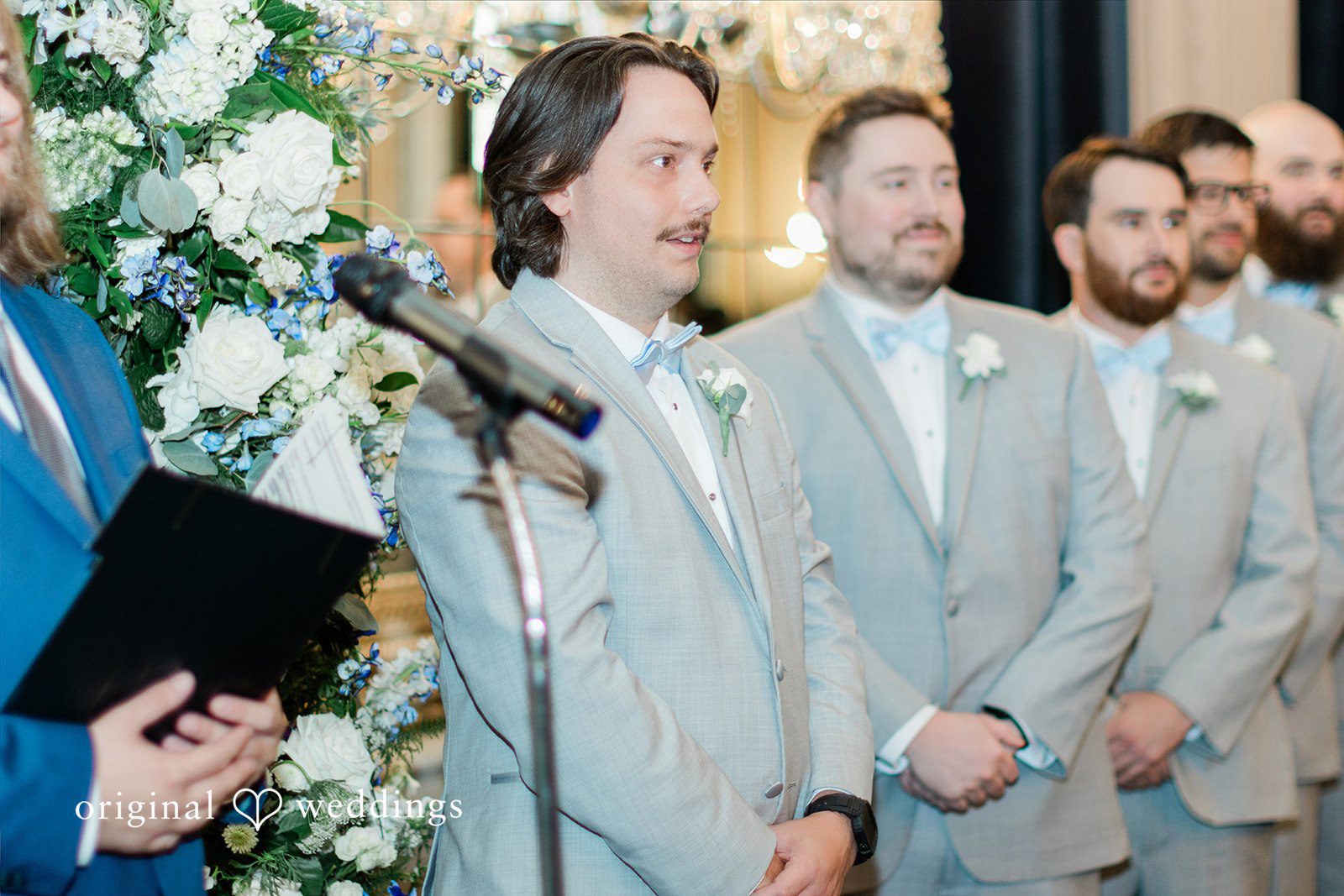 Sara + Michael A groom laughing and waiting for bride while standing at the altar with his groomsmen.