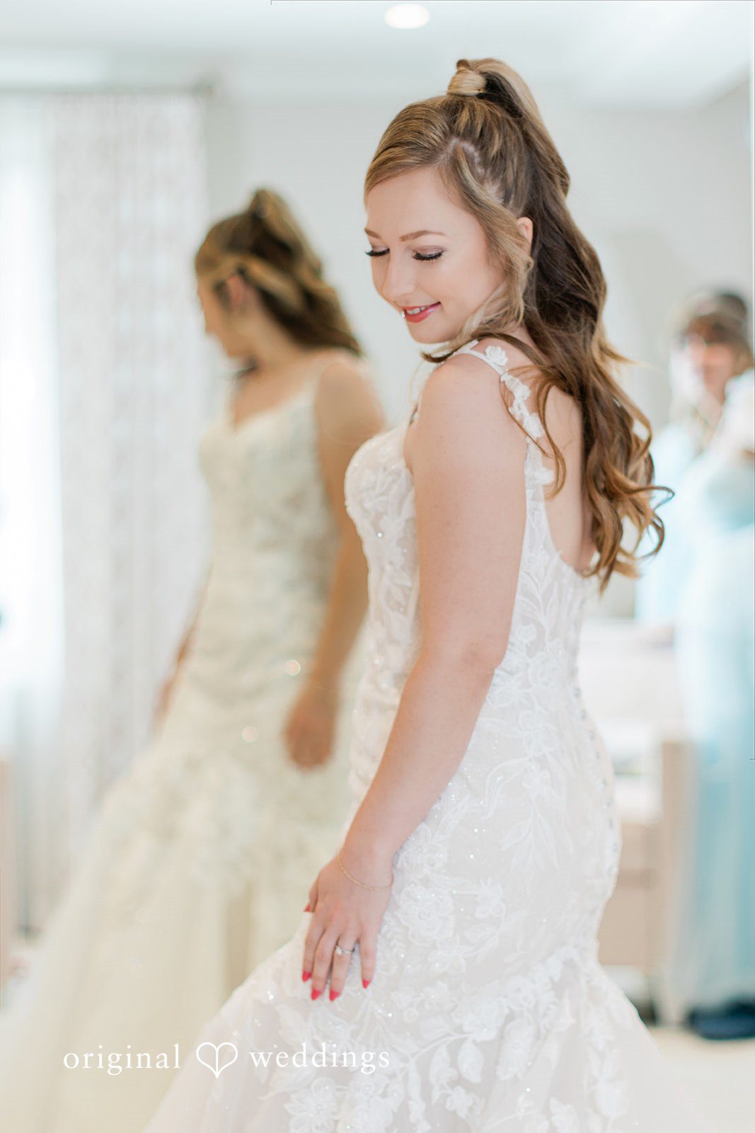 Sara + Michael A bride laughing and celebrating with her bridesmaids in a bright room.