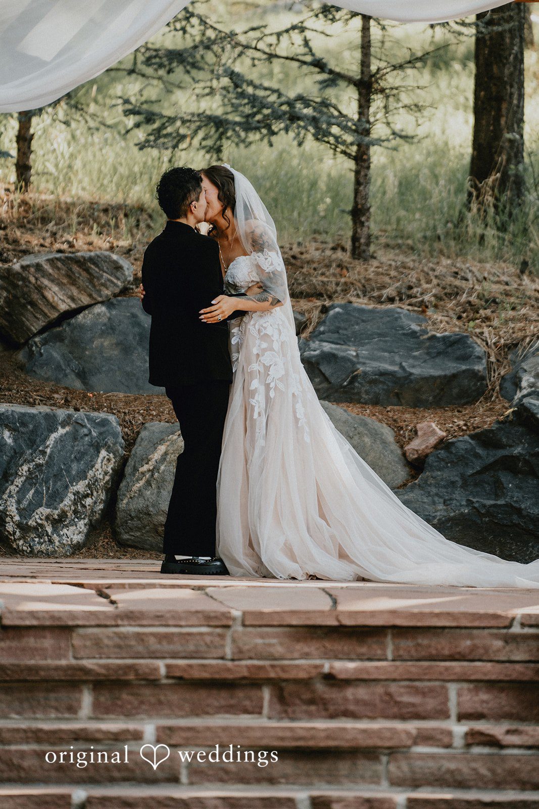 Jennifer + Danielle A couple embrace during their wedding ceremony.