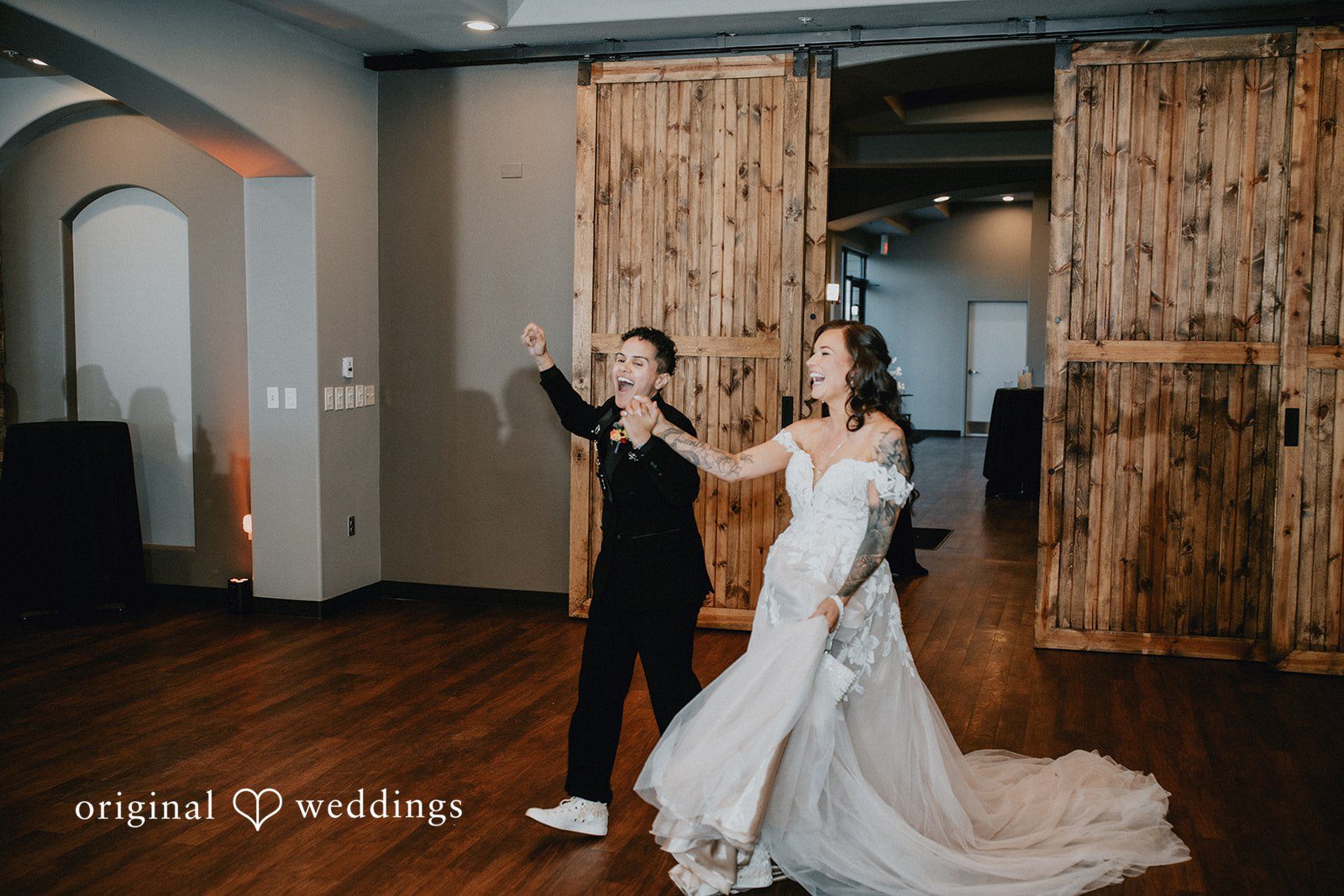 Jennifer + Danielle A newlywed couple celebrates their entrance into the reception venue.