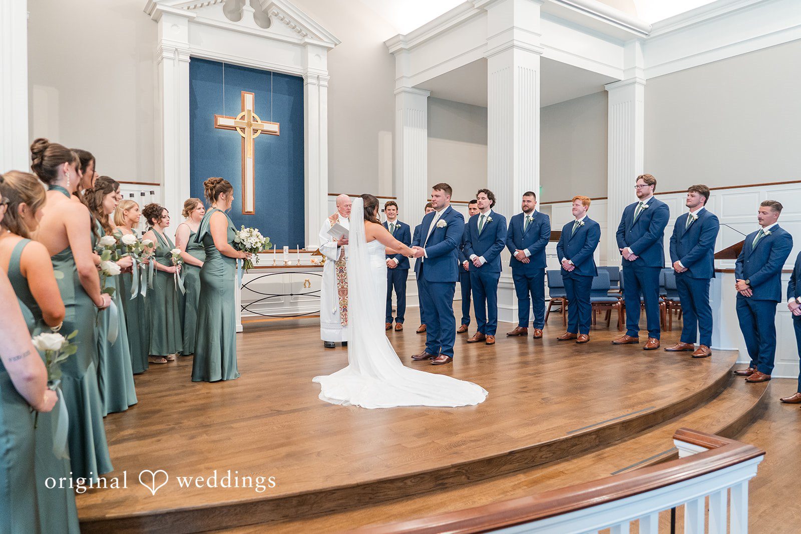 Chelsea + Matthew Couple enjoying ceremony moments while holding each other hands infront of guests at The Rivulet