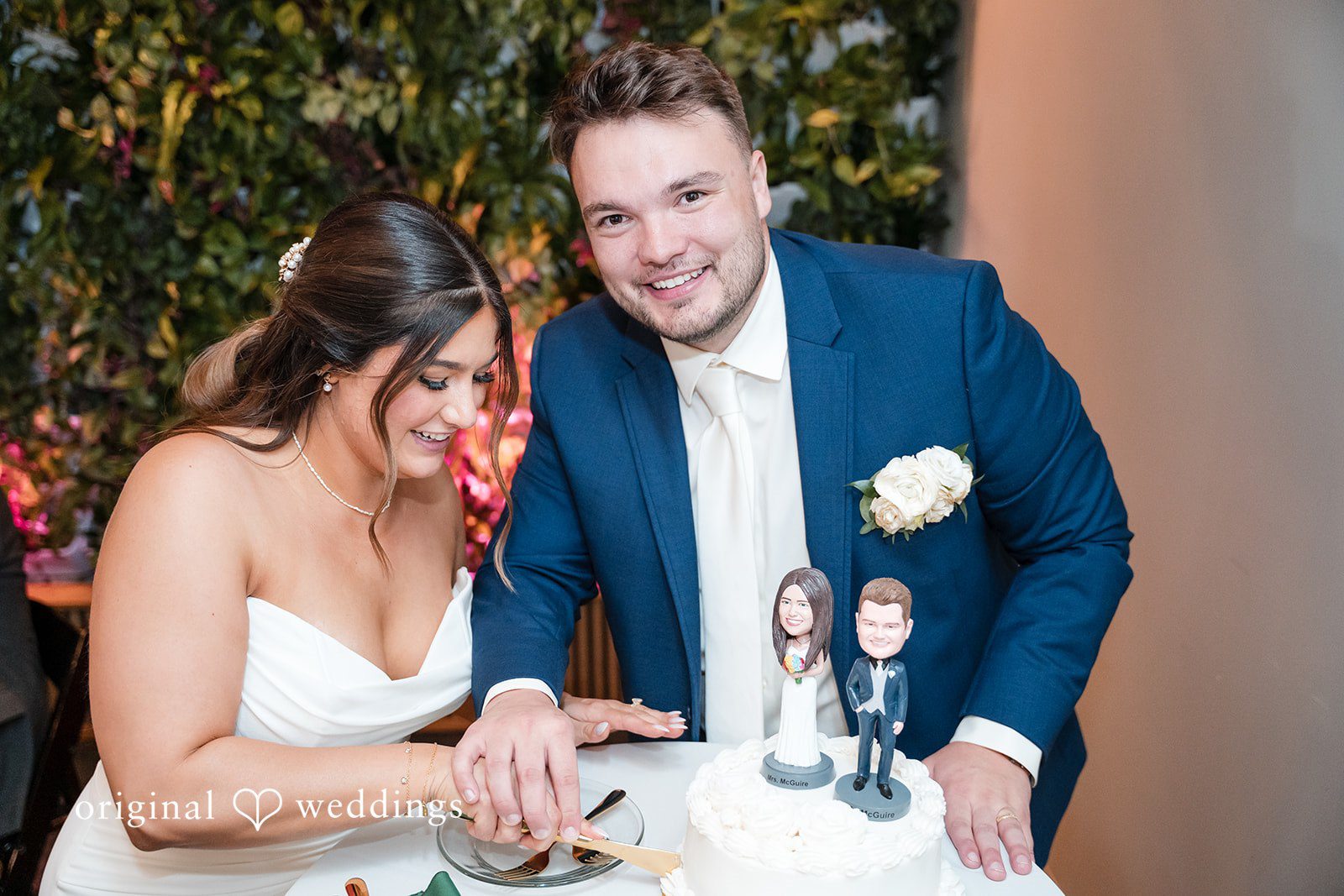 Chelsea + Matthew Bride and groom cutting cake together at The Rivulet