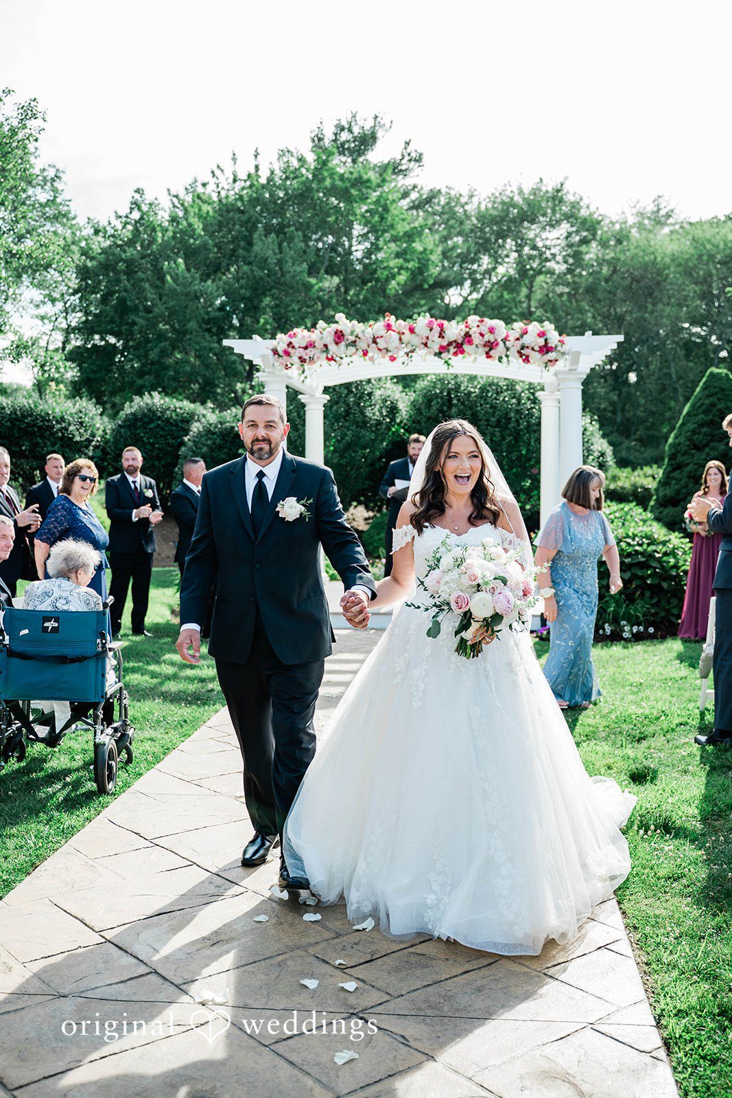 A bride and groom walking down the aisle together after getting married.