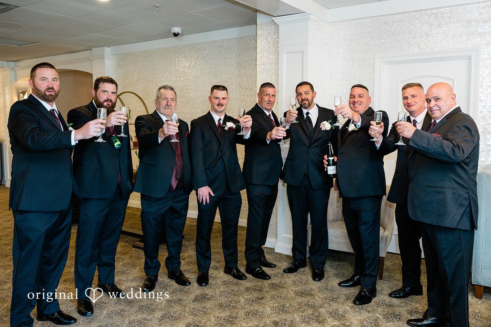 A groom and his groomsmen posing together.