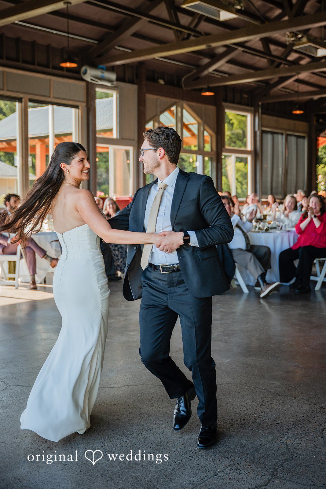 Zechariah + Tova A bride and groom dancing joyfully together at their wedding reception.