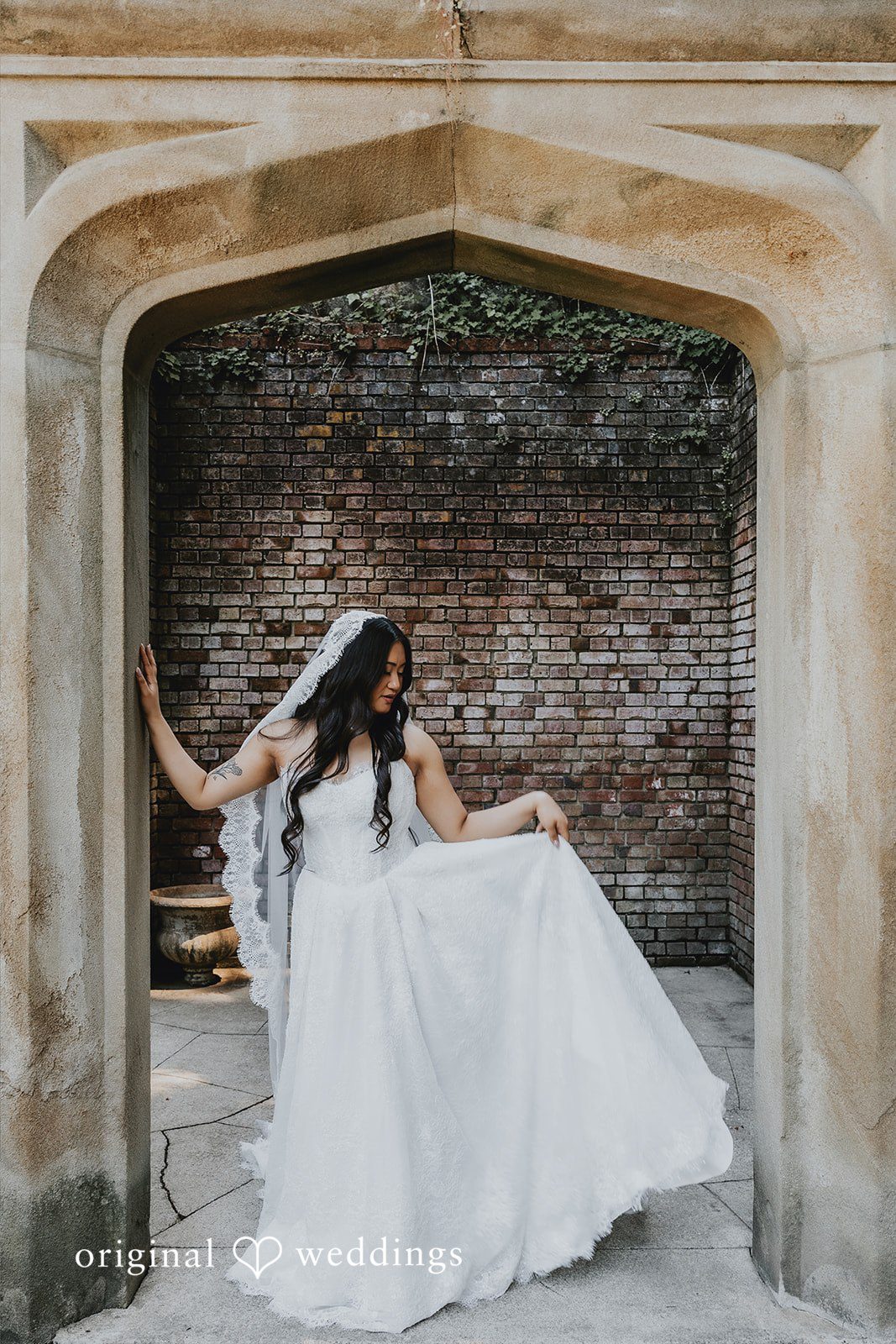 Sharmaine + Ronald A bride sitting gracefully on a stone bench in a wedding gown.