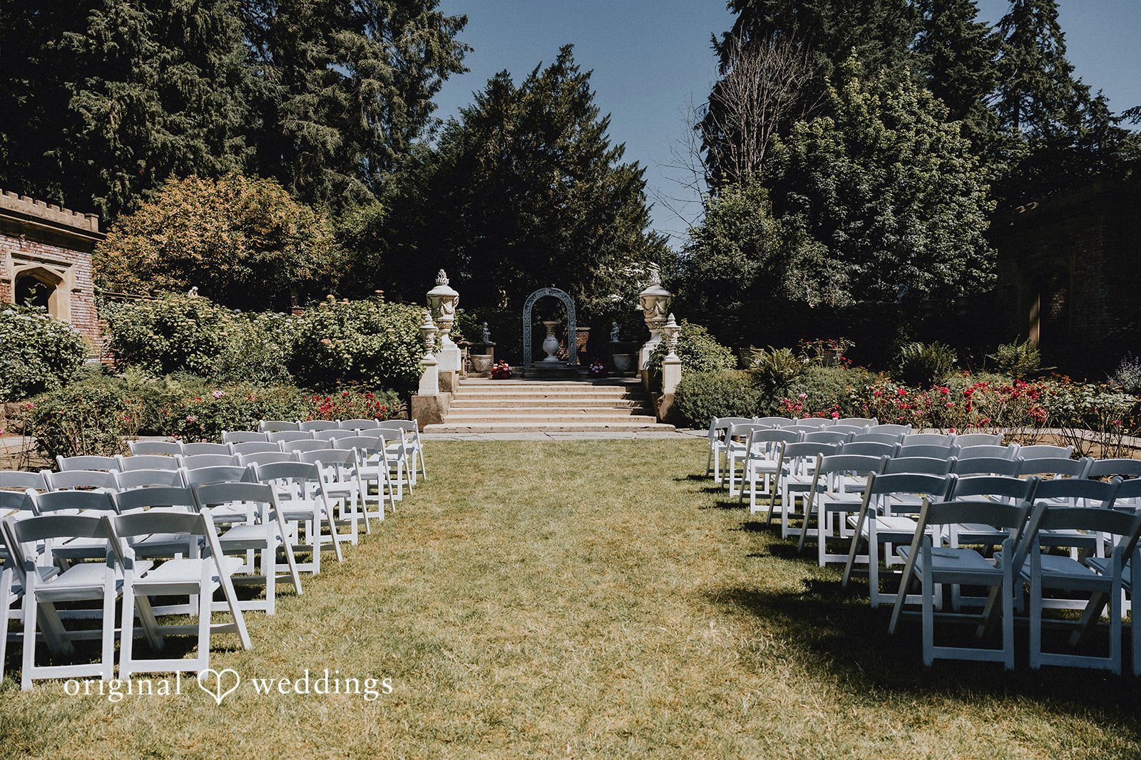 Sharmaine + Ronald Wedding ceremony seating arranged on a grassy lawn.