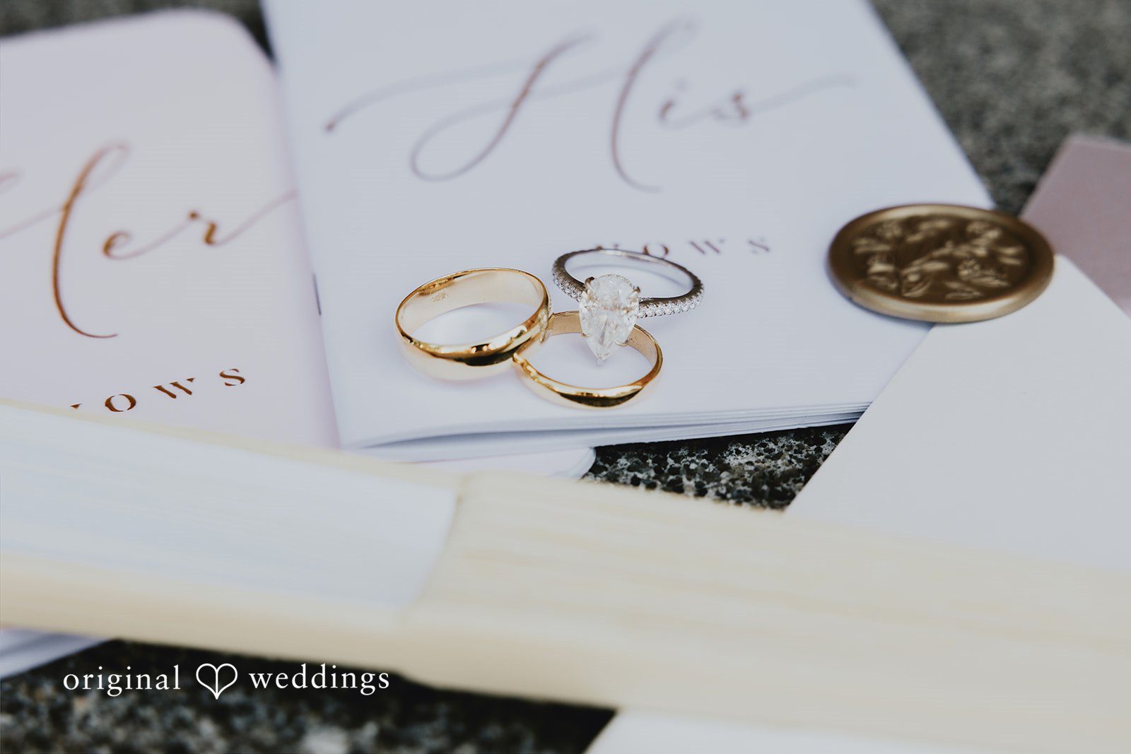 Sharmaine + Ronald Wedding rings placed next to a personalized stationery card.