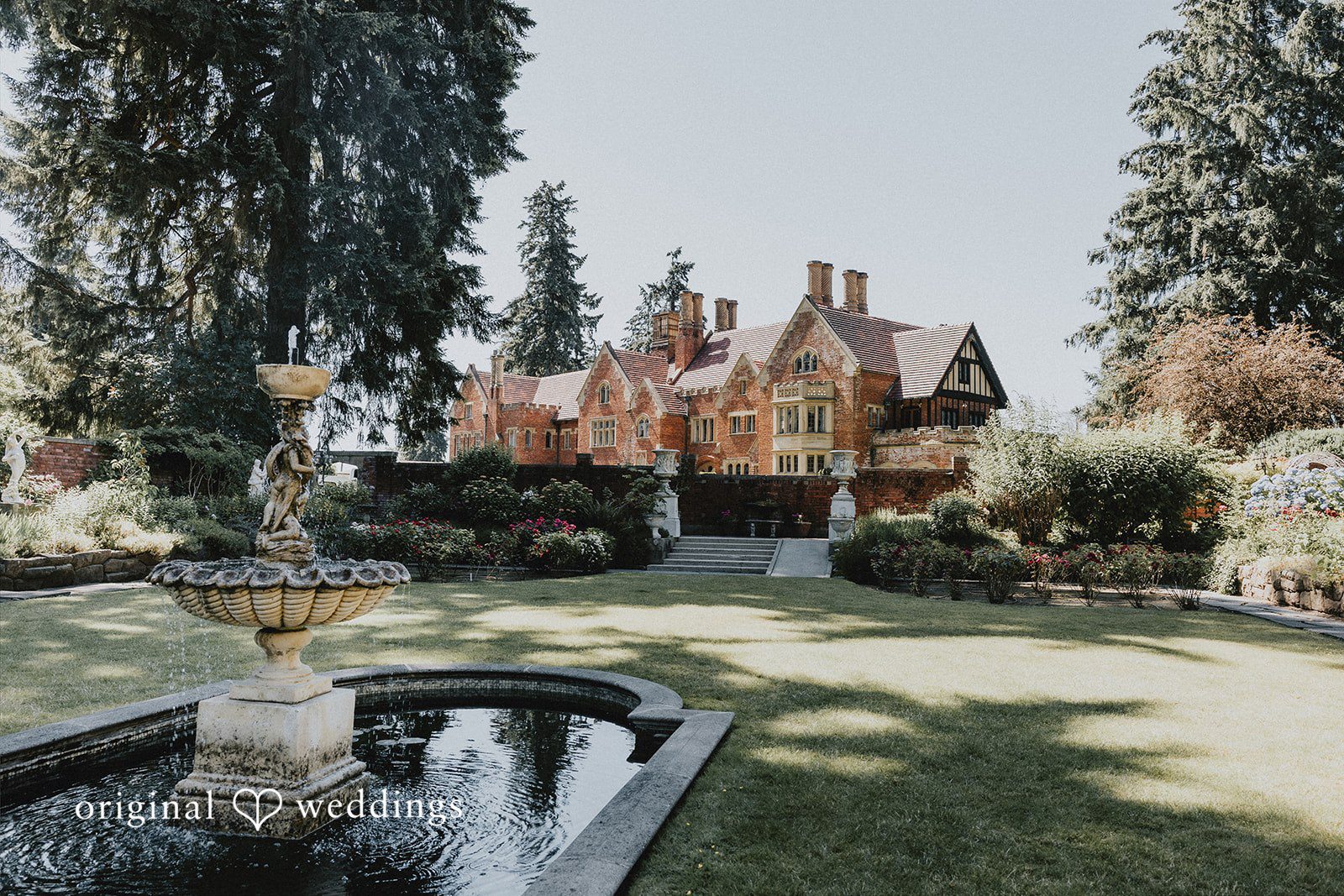 Sharmaine + Ronald A brick manor house surrounded by manicured green gardens.