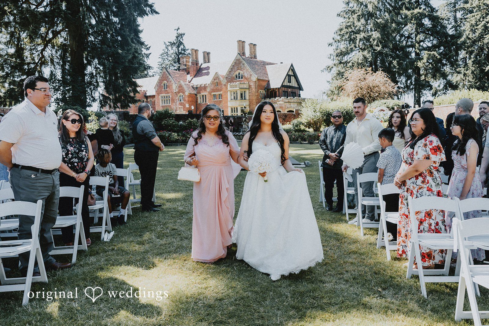 Sharmaine + Ronald Bride walking down a grassy aisle lined with white chairs.
