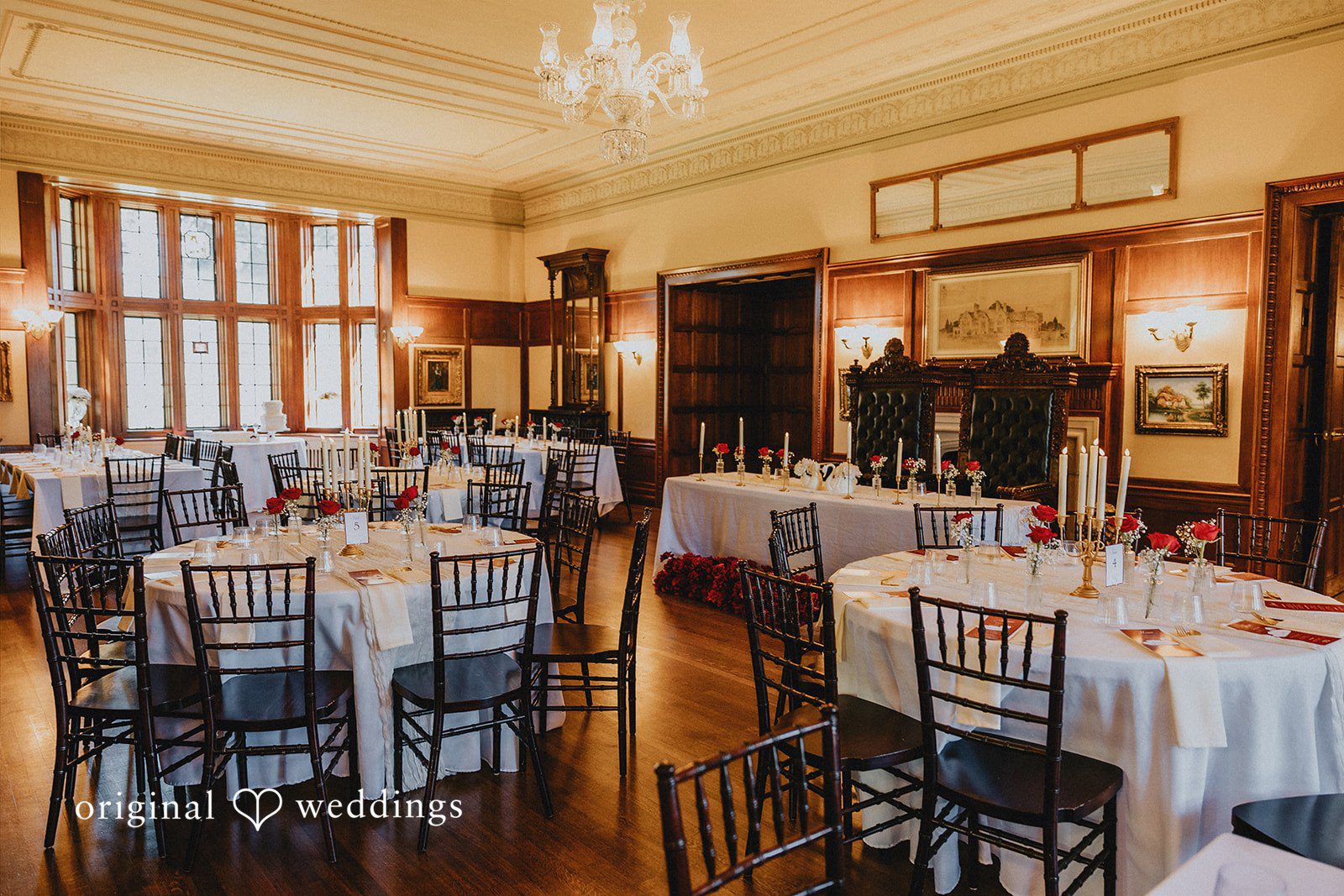 Sharmaine + Ronald A formal banquet hall set up with dining tables and chairs.