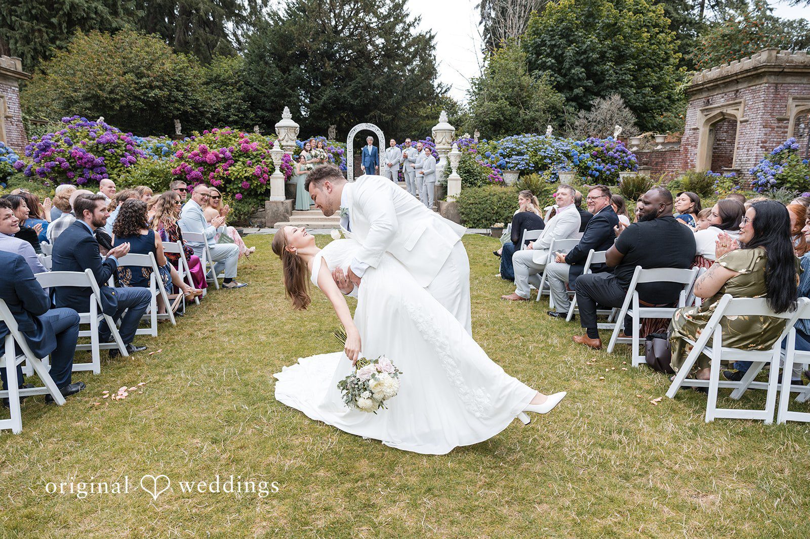 Our Seattle wedding photographers at Original Weddings captured a romantic portrait of the couple on the aisle at the Thornewood Castle