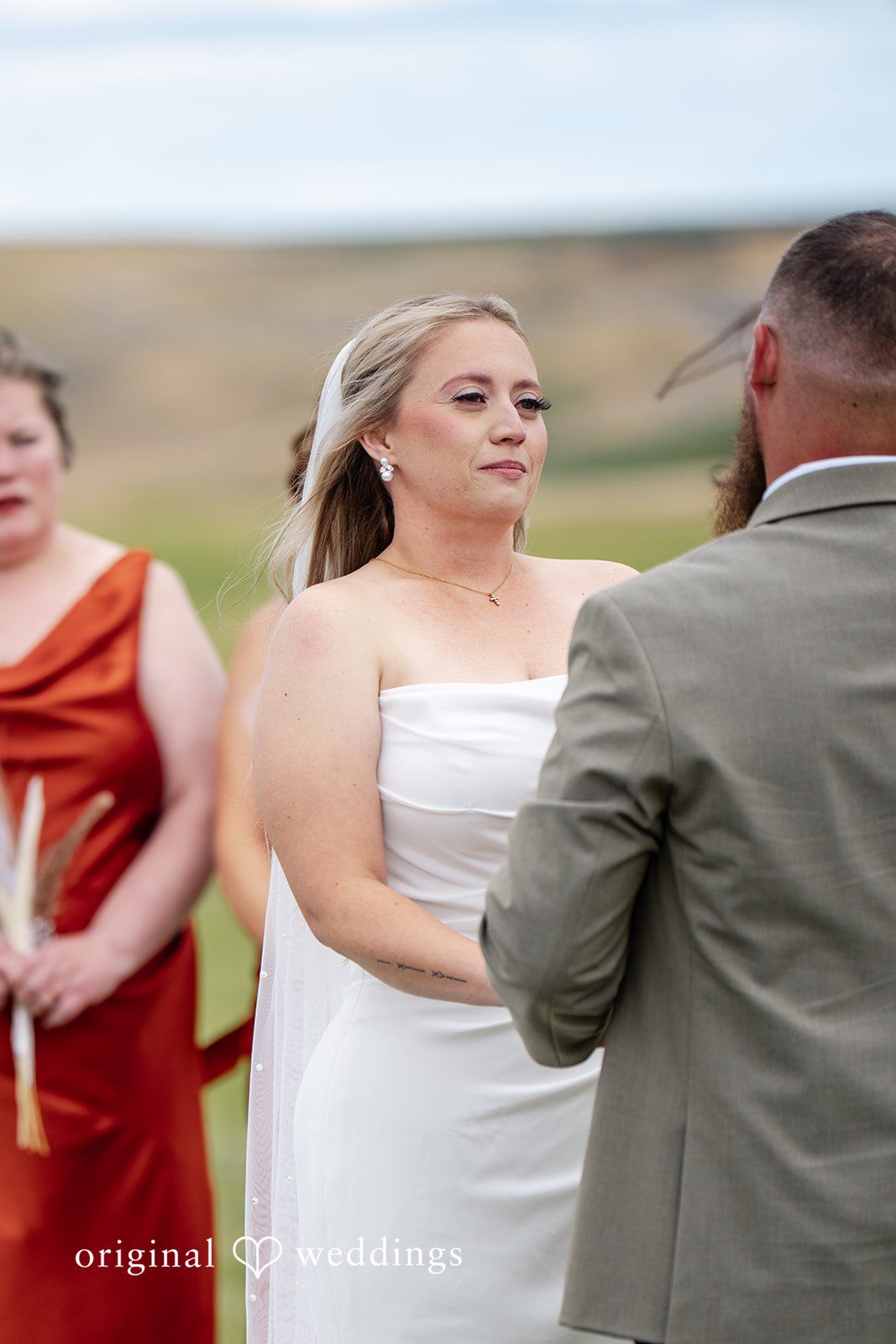 Kayla + Dillon A bride looking into the eyes of her groom while standing at Tin Roof Barn.