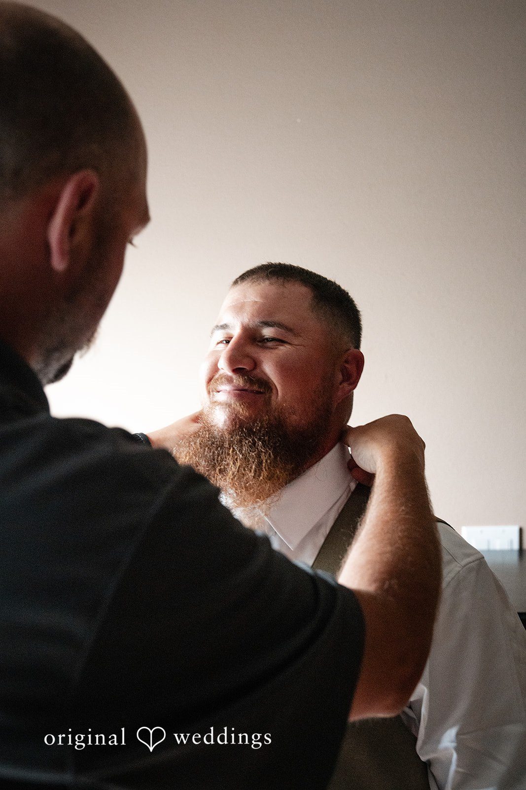Kayla + Dillon A groom having his collar adjusted before the wedding ceremony begins.