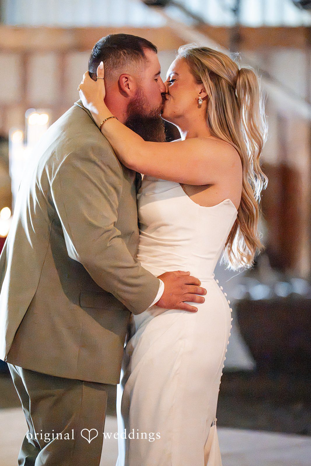 Kayla + Dillon A close-up shot of a bride and groom sharing a passionate kiss on the dance floor.