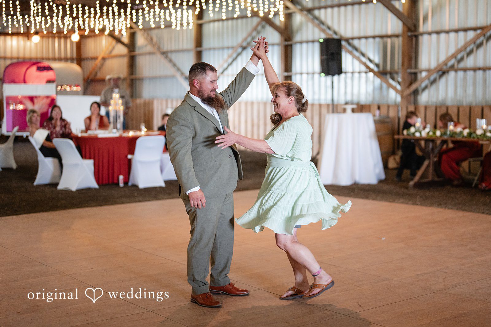 Kayla + Dillon A groom dancing playfully with a female guest during the wedding reception.