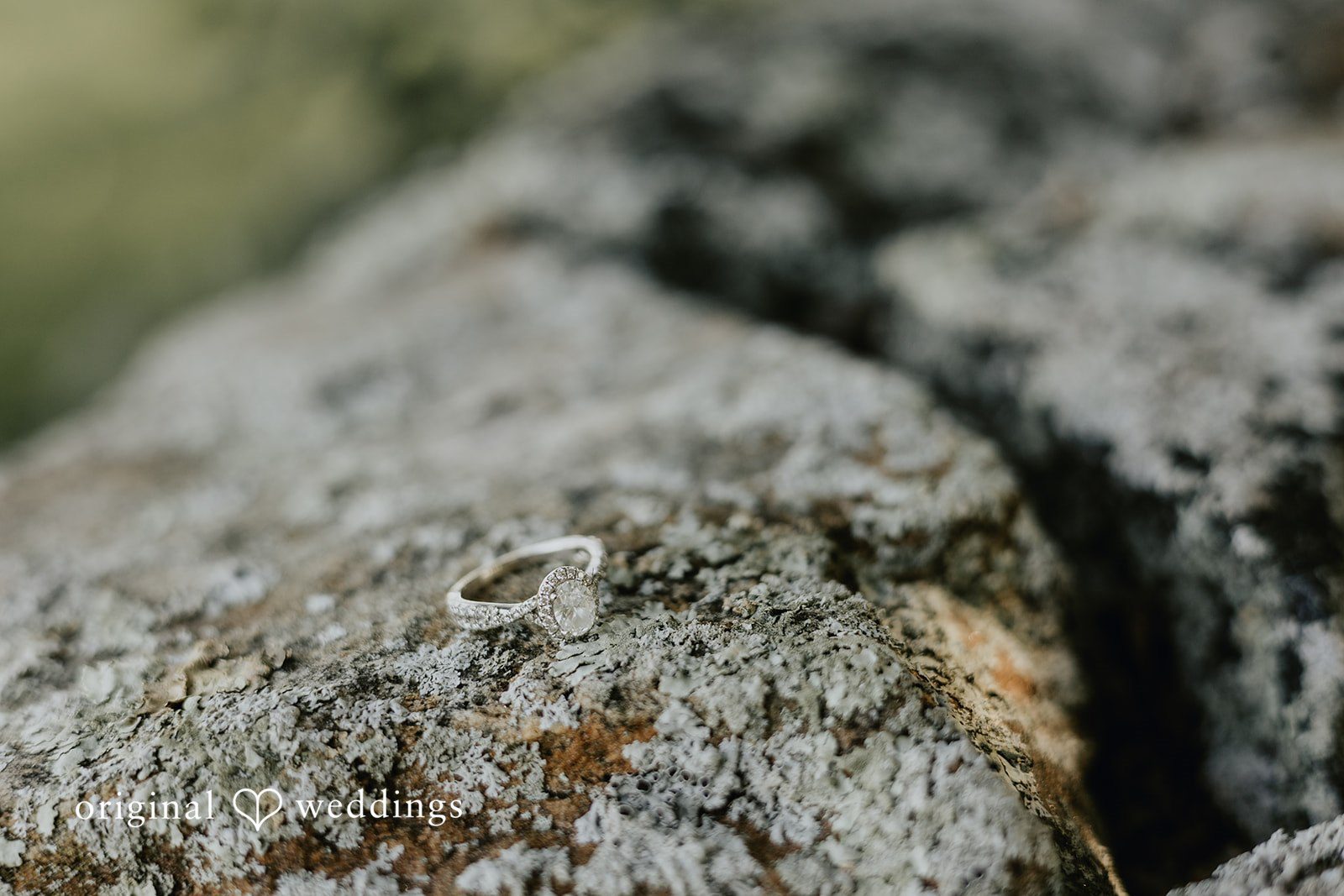 Meghan + Kal A close-up view of engagement ring and focusing on the rough texture of a large rock.