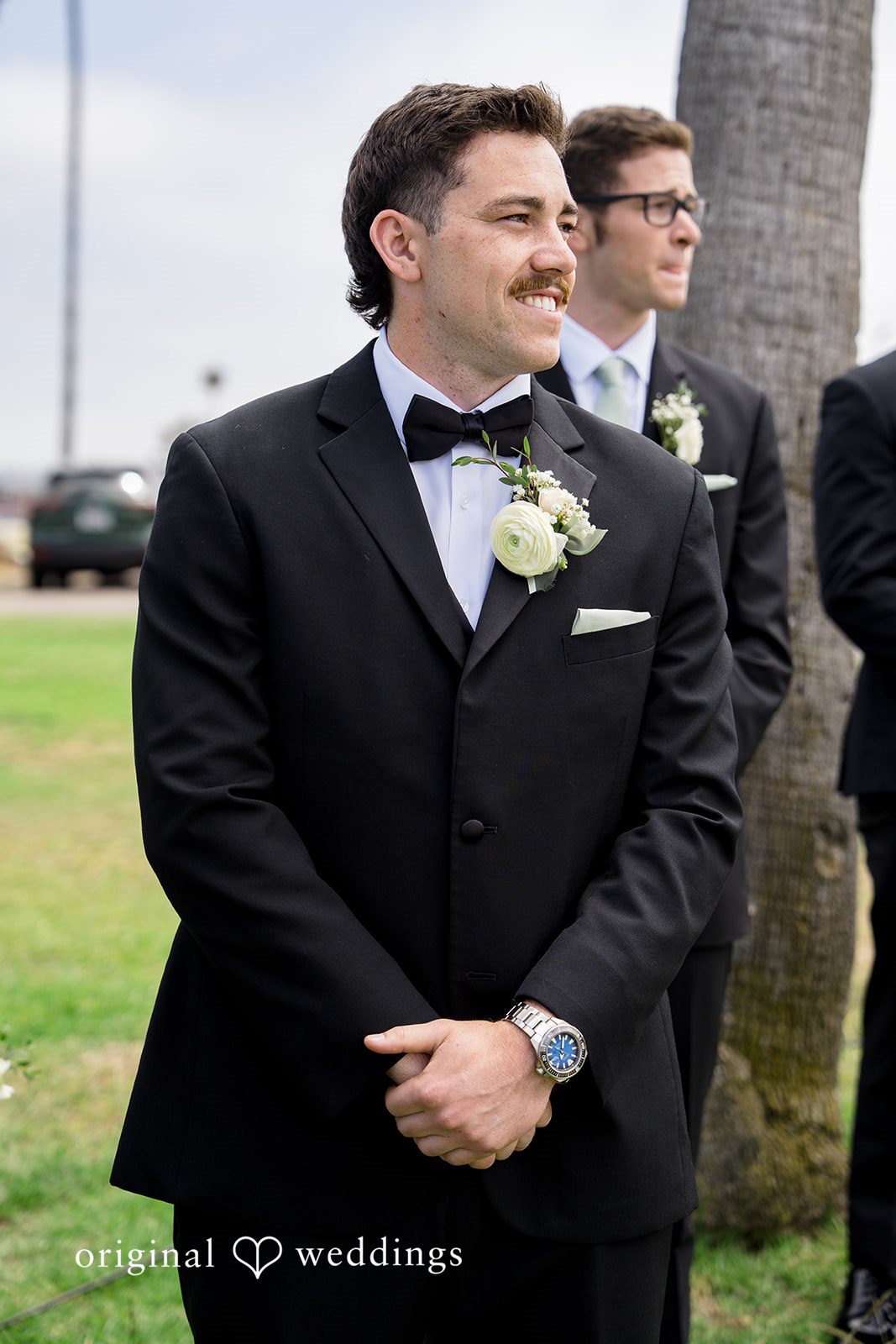 Kalina + Malakai A groom smiling while standing at the wedding venue.