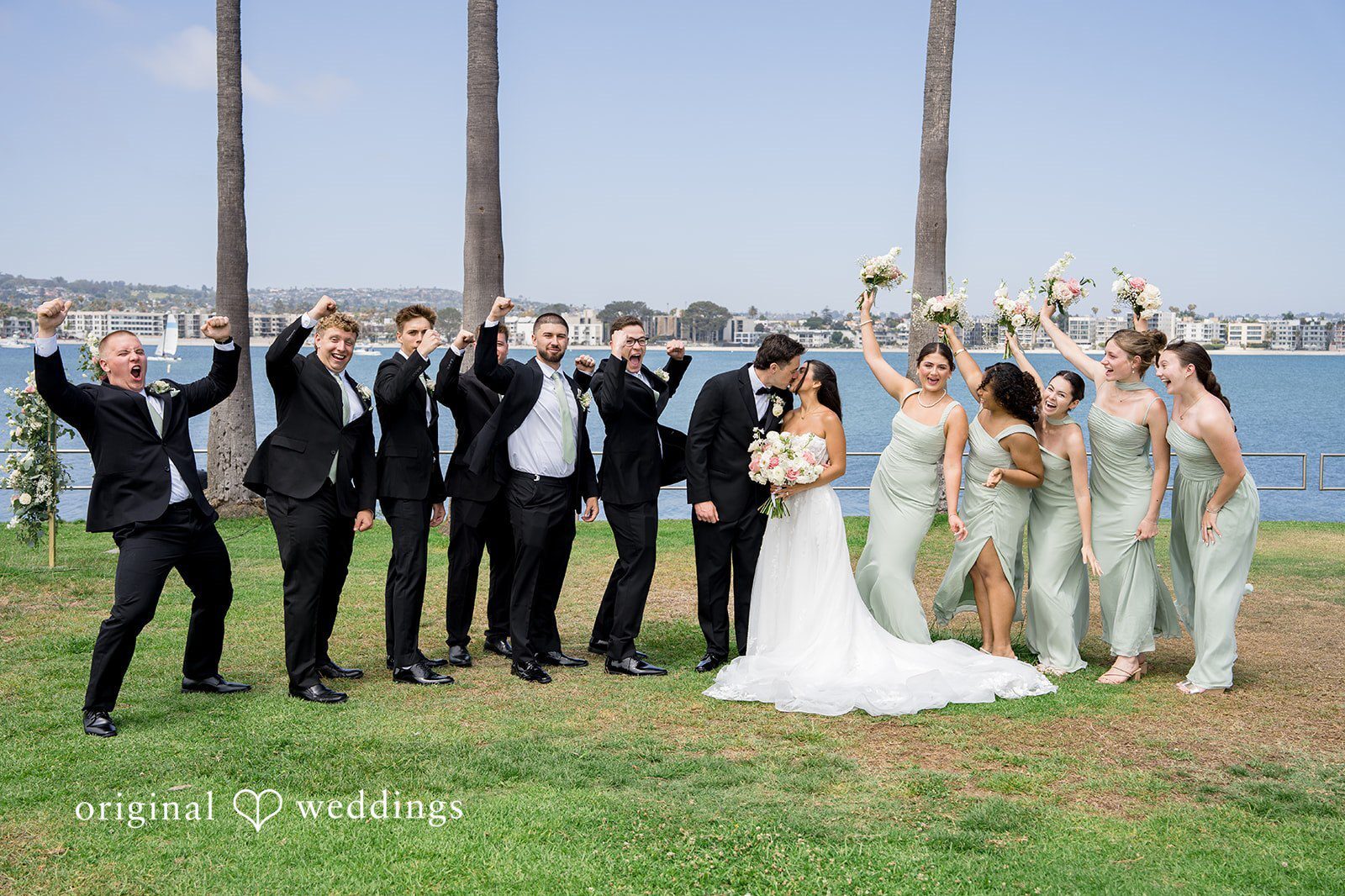 Wedding party posing together captured by San Diego Wedding Photographers from Original Weddings at Tower Beach Club