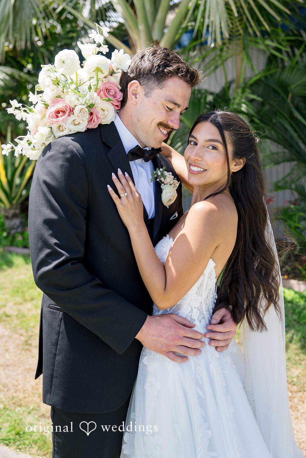 Kalina + Malakai Groom holding the bride close while they share a joyful hug.