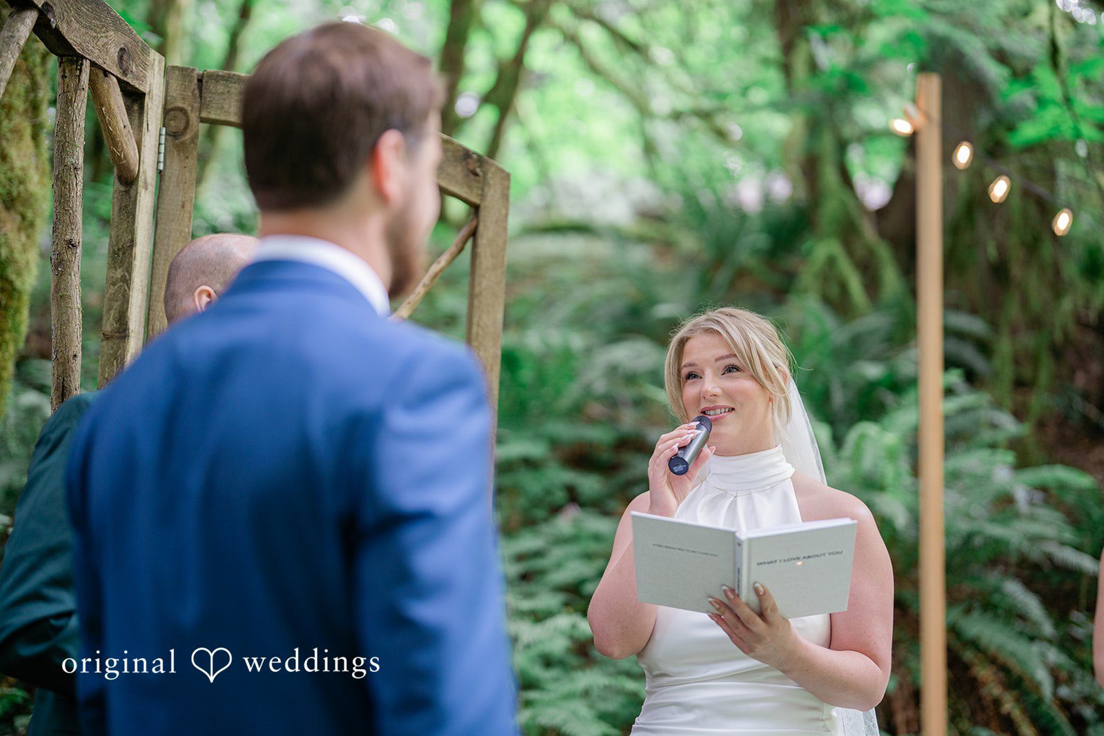 Destiny + Maksim A bride reading her vows from a book to the groom during their ceremony.