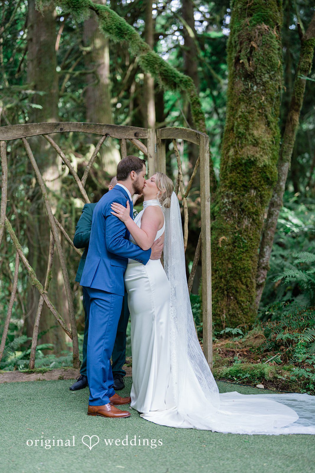 Destiny + Maksim A bride and groom sharing a kiss at the altar.