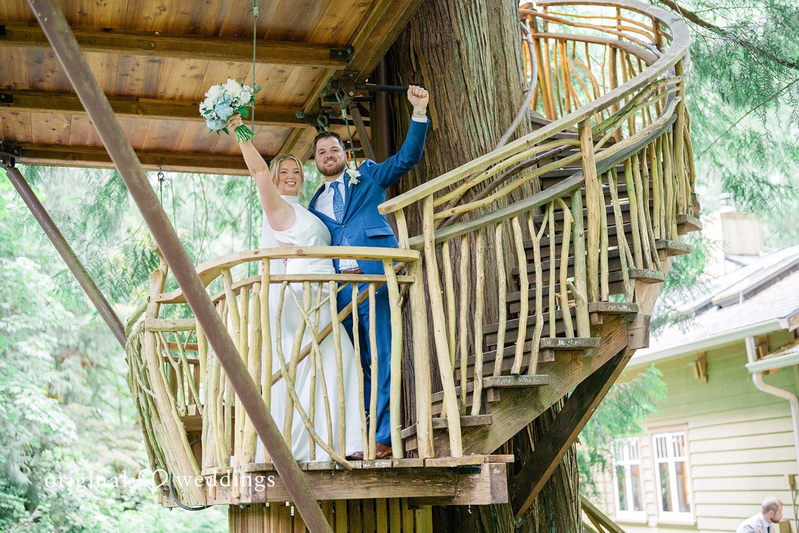 Destiny + Maksim A groom waving his hand while standing on a high wooden balcony.