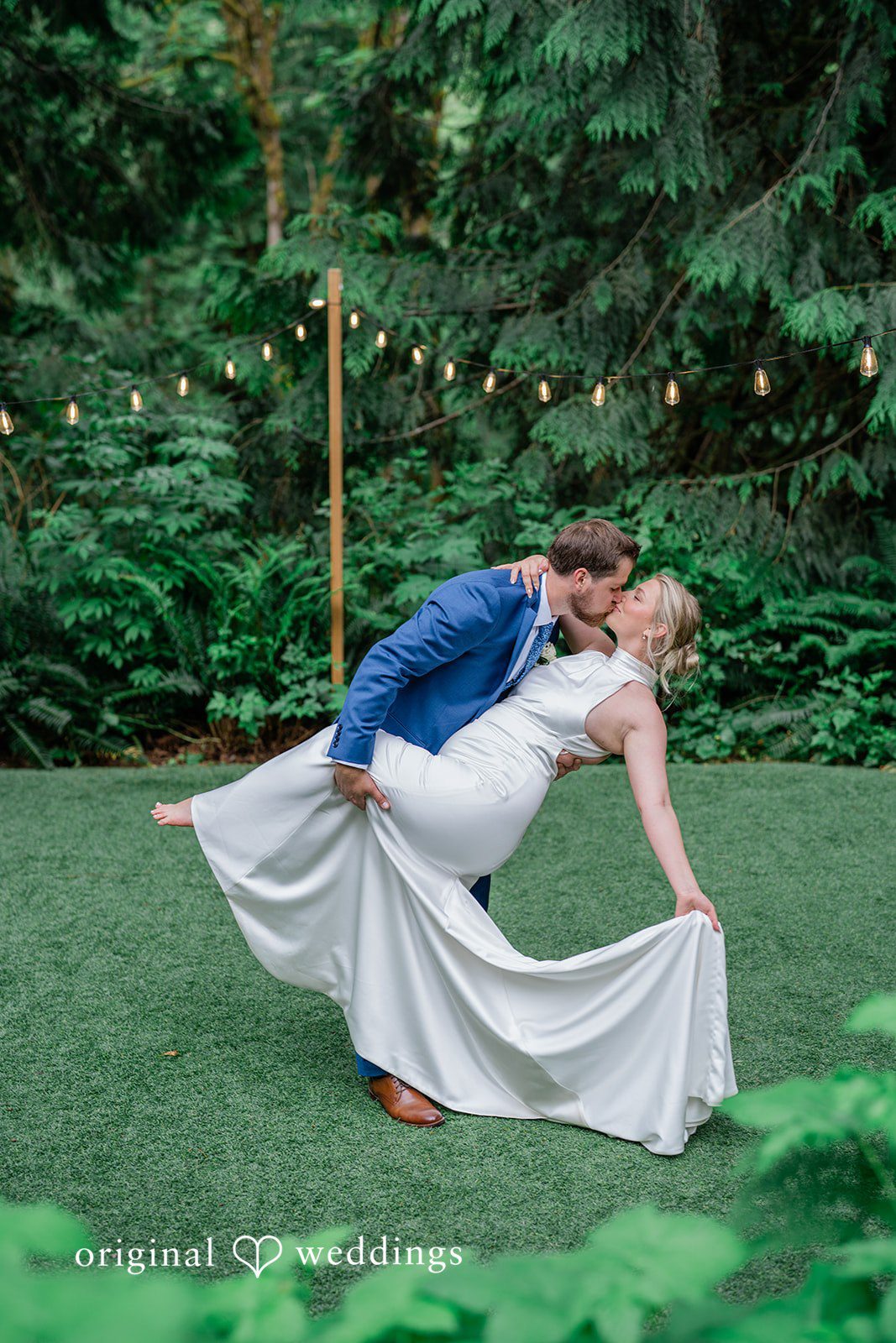 Destiny + Maksim A groom dipping his bride low to the ground for a dramatic pose.
