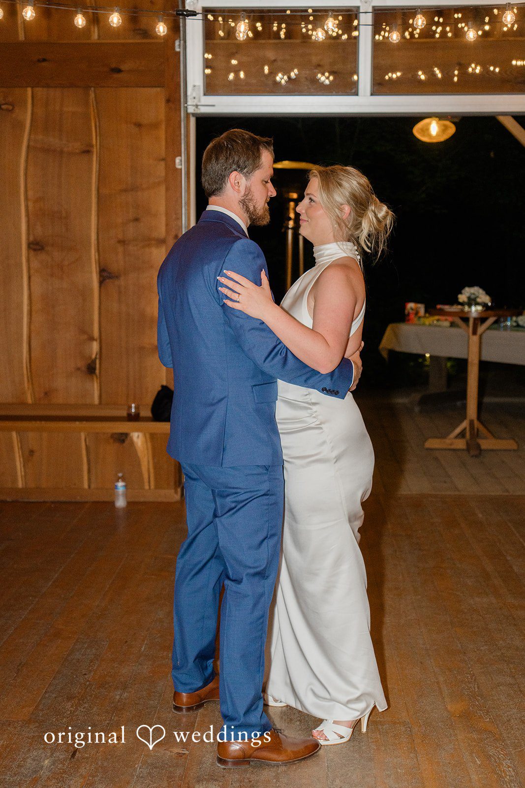 Destiny + Maksim A bride and groom dancing together in the center of a rustic hall.