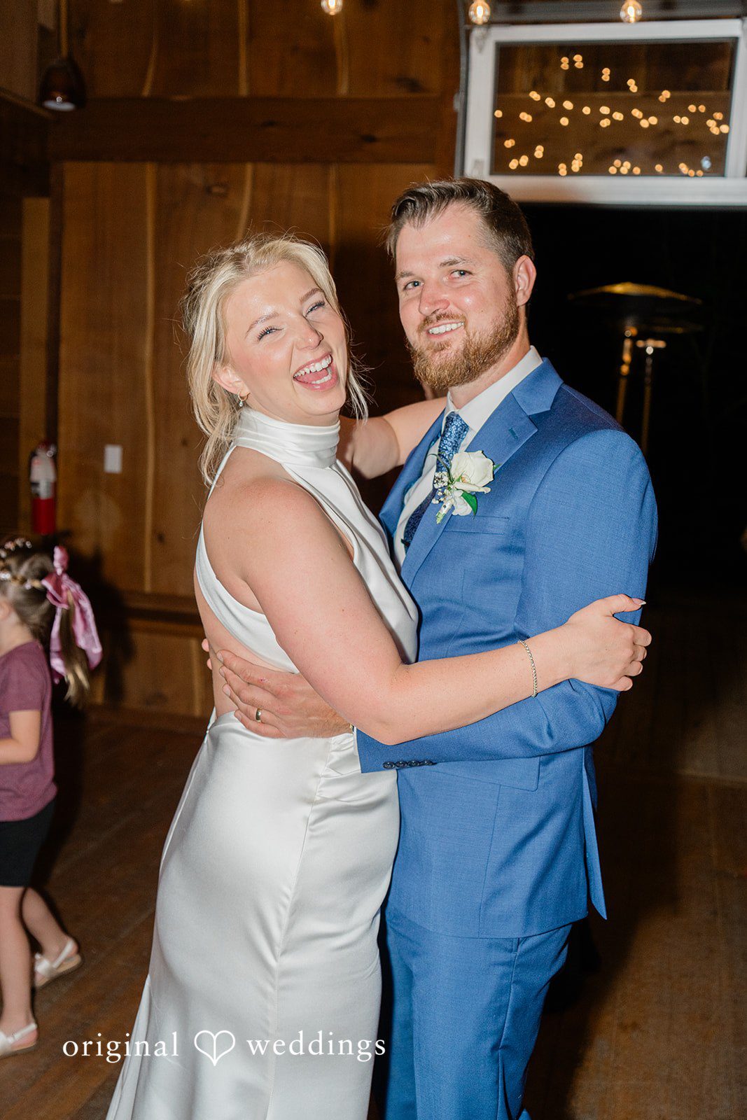 Destiny + Maksim A groom holding his bride from behind during their wedding reception dance.